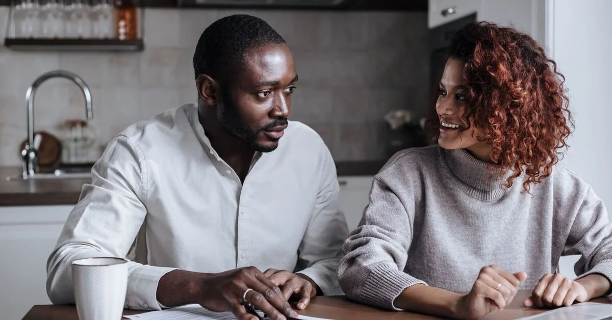 Couple sitting at kitchen table, depicting ADHD communication problems