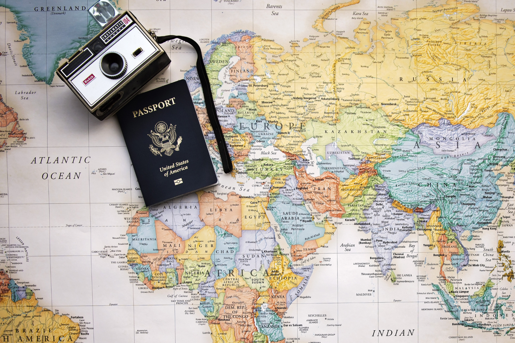 Camera and Passport on map - where will you go next?