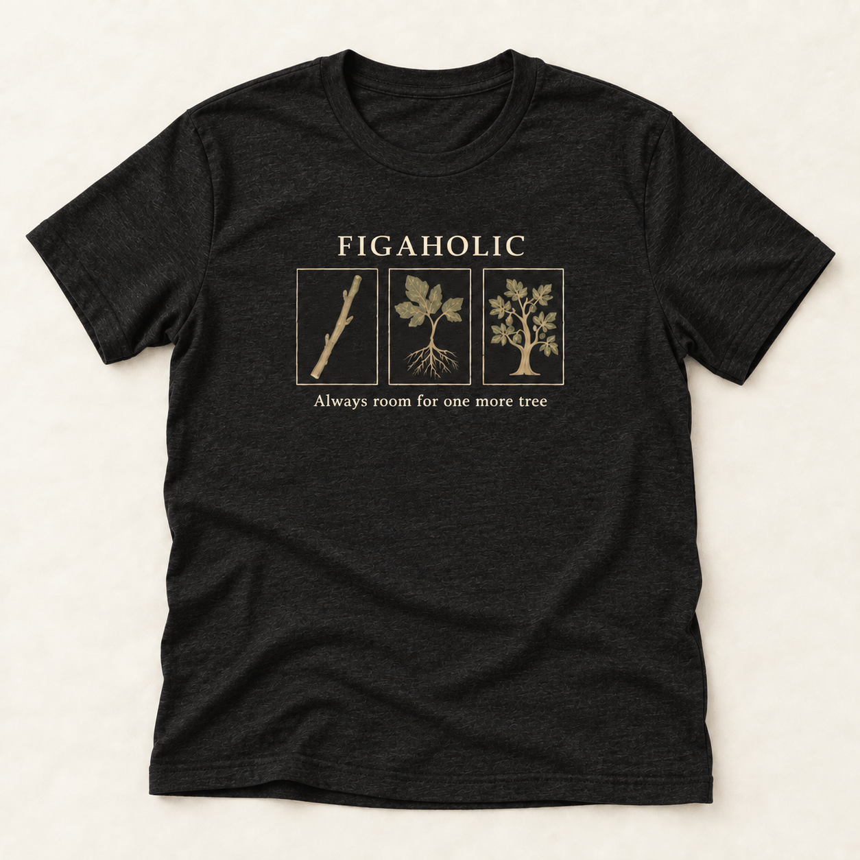 Black Heather FIGAHOLIC T-shirt flat lay with three botanical panels showing a fig cutting, rooted plant and fruiting tree.
