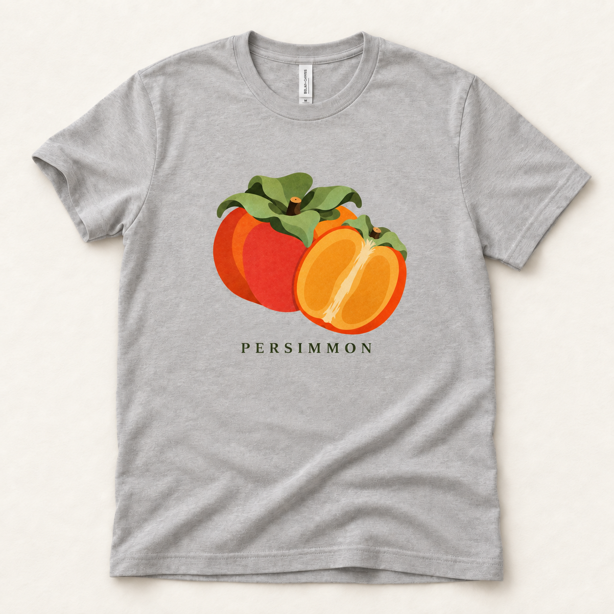 Athletic Heather Persimmon T-shirt with a whole orange persimmon, a golden cut half and green leaves printed on the front.