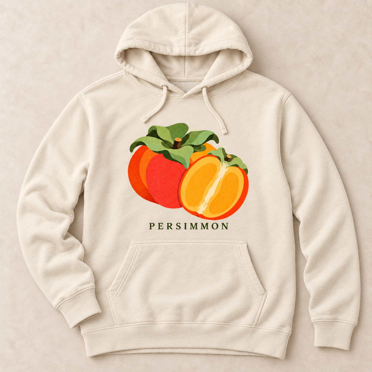 Bone Persimmon pullover hoodie with a whole orange persimmon, a cut half and green leaves above the front pocket.
