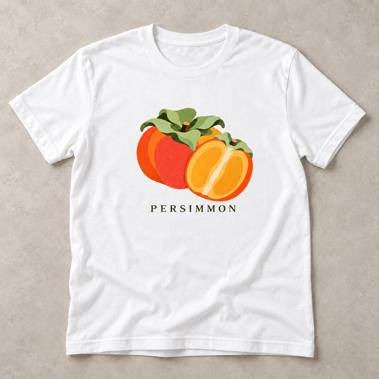 White Persimmon T-shirt with a whole orange persimmon, a golden cut half and green leaves printed on the front.