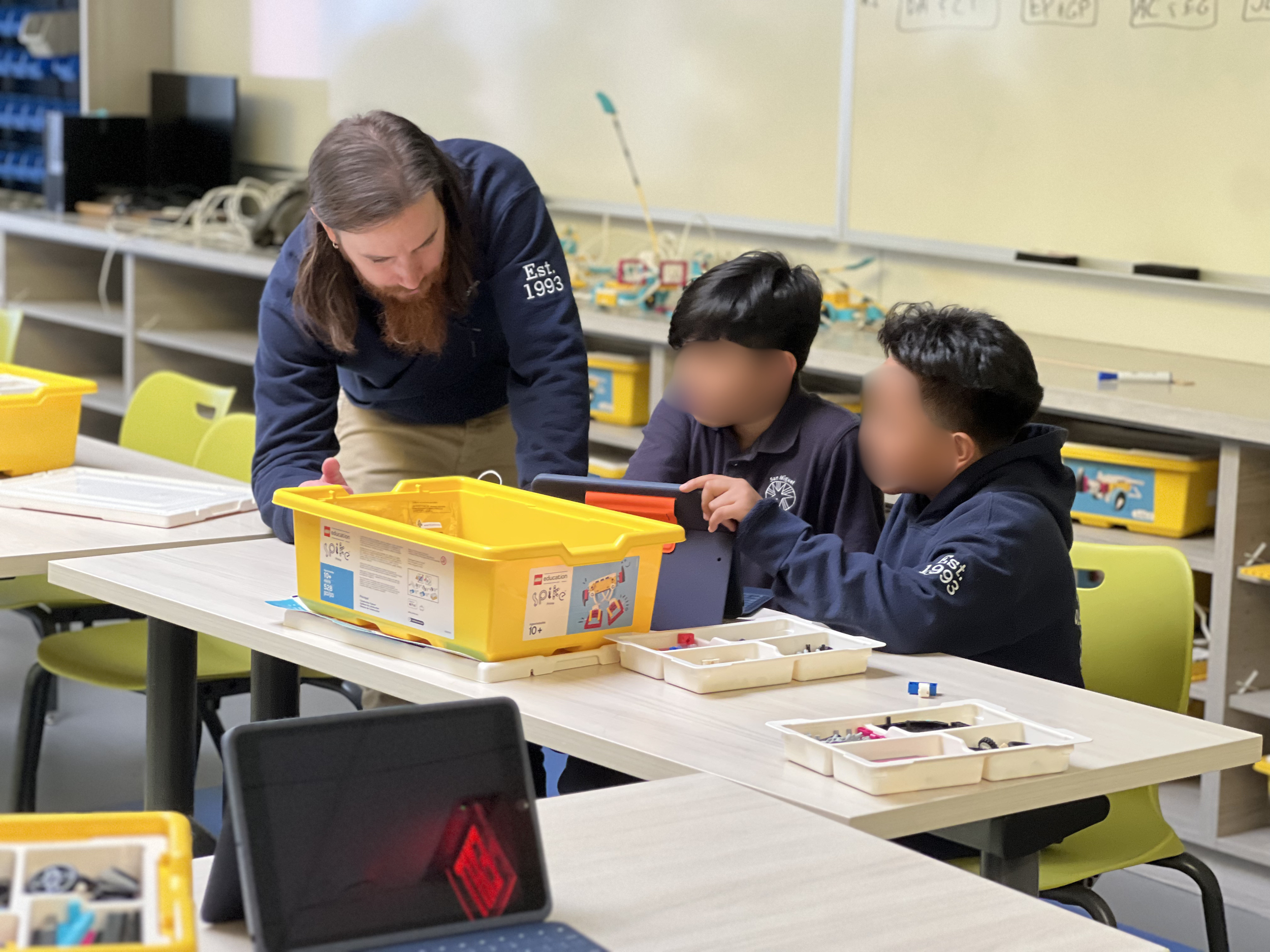 One of the San Miguel Teachers teaching the students about code.
