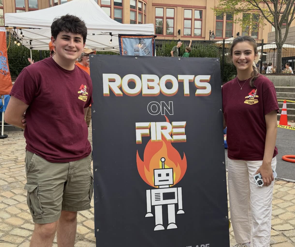 Robotics Members holding up a "Robots on Fire" sign.