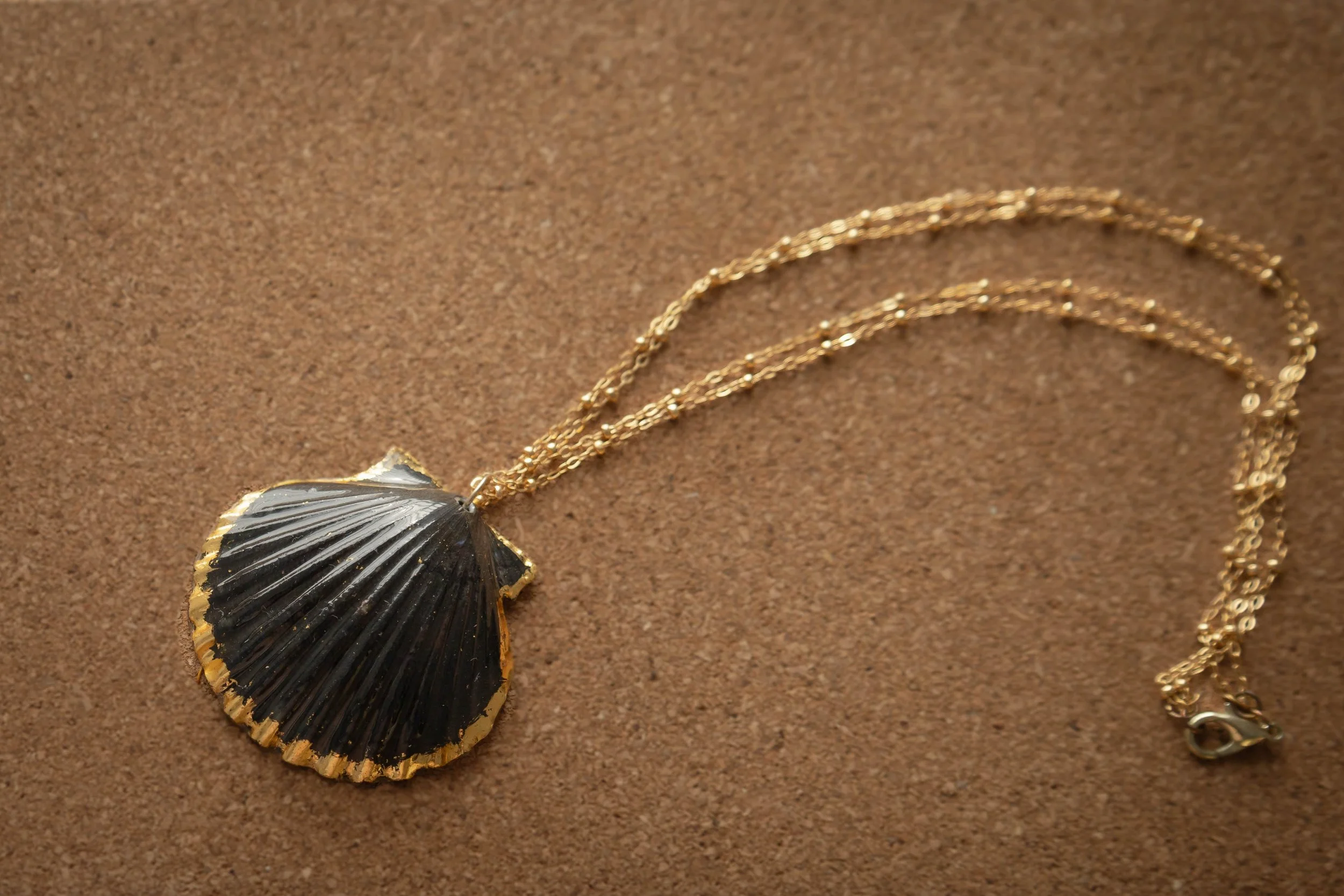 blackandneatgoldpendant.jpg