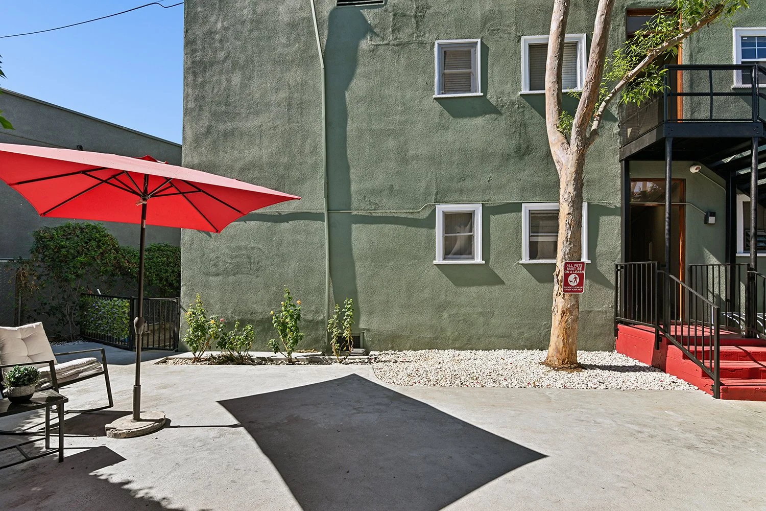 Cahuenga Exterior courtyard with seating and umbrellas. 