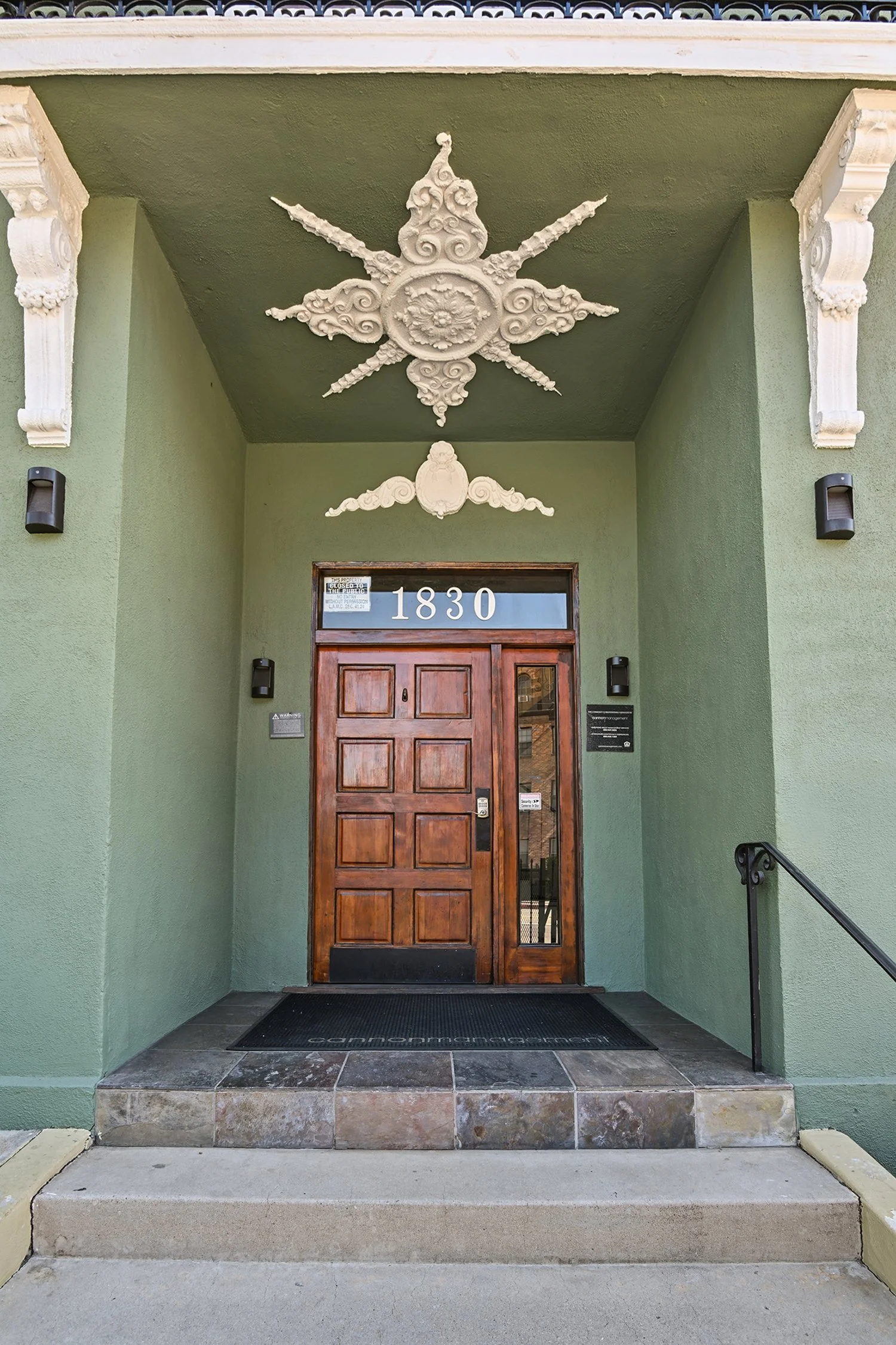 Charming entrance to Cahuenga Apartments with beautiful architectural detailing and wood entry door. 