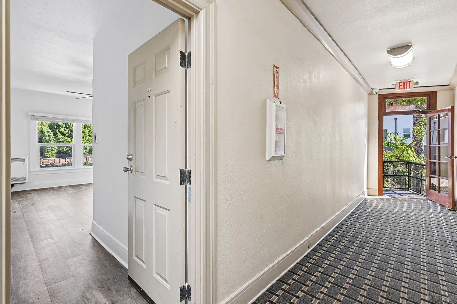 Hallway at Cahuenga Apartments with cool carpet and charming architectural details. 