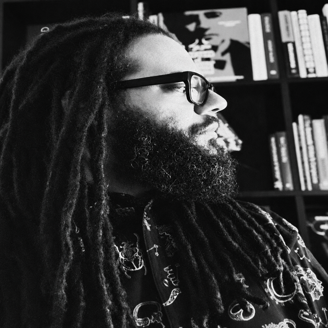 SJ Alexander in profile in a studio library.