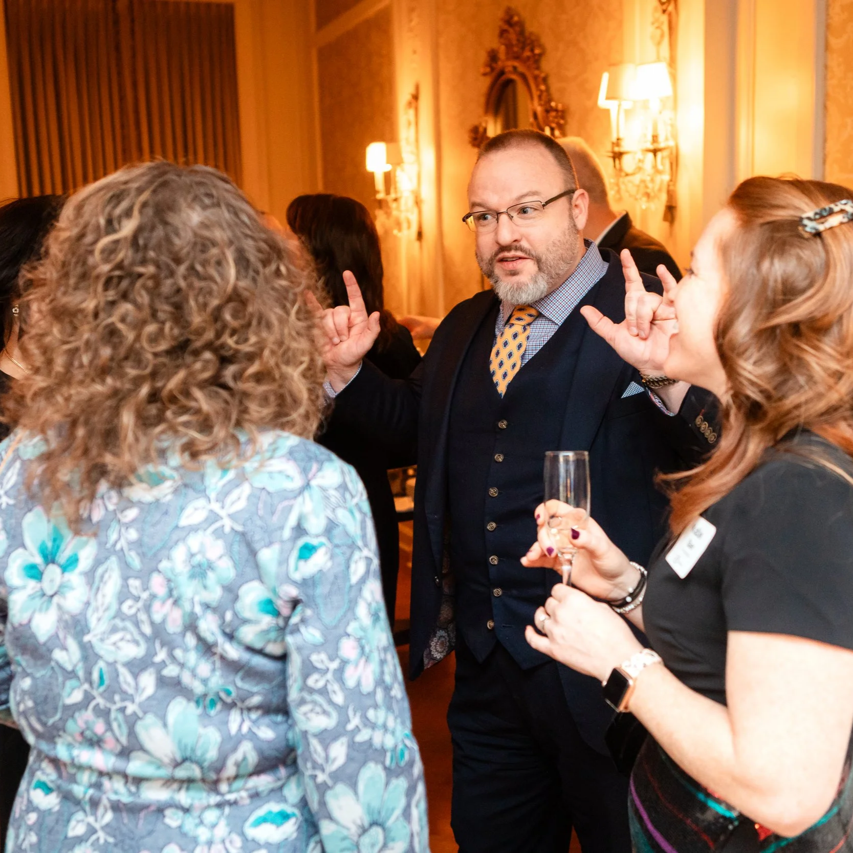 Nicholas Gentry engaging guests during a corporate cocktail reception