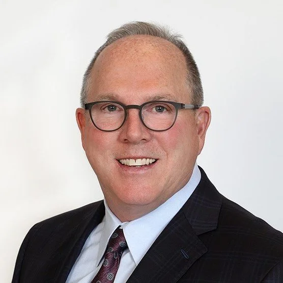 A headshot of Bruce White — CEO, Johnson, Kendall & Johnson