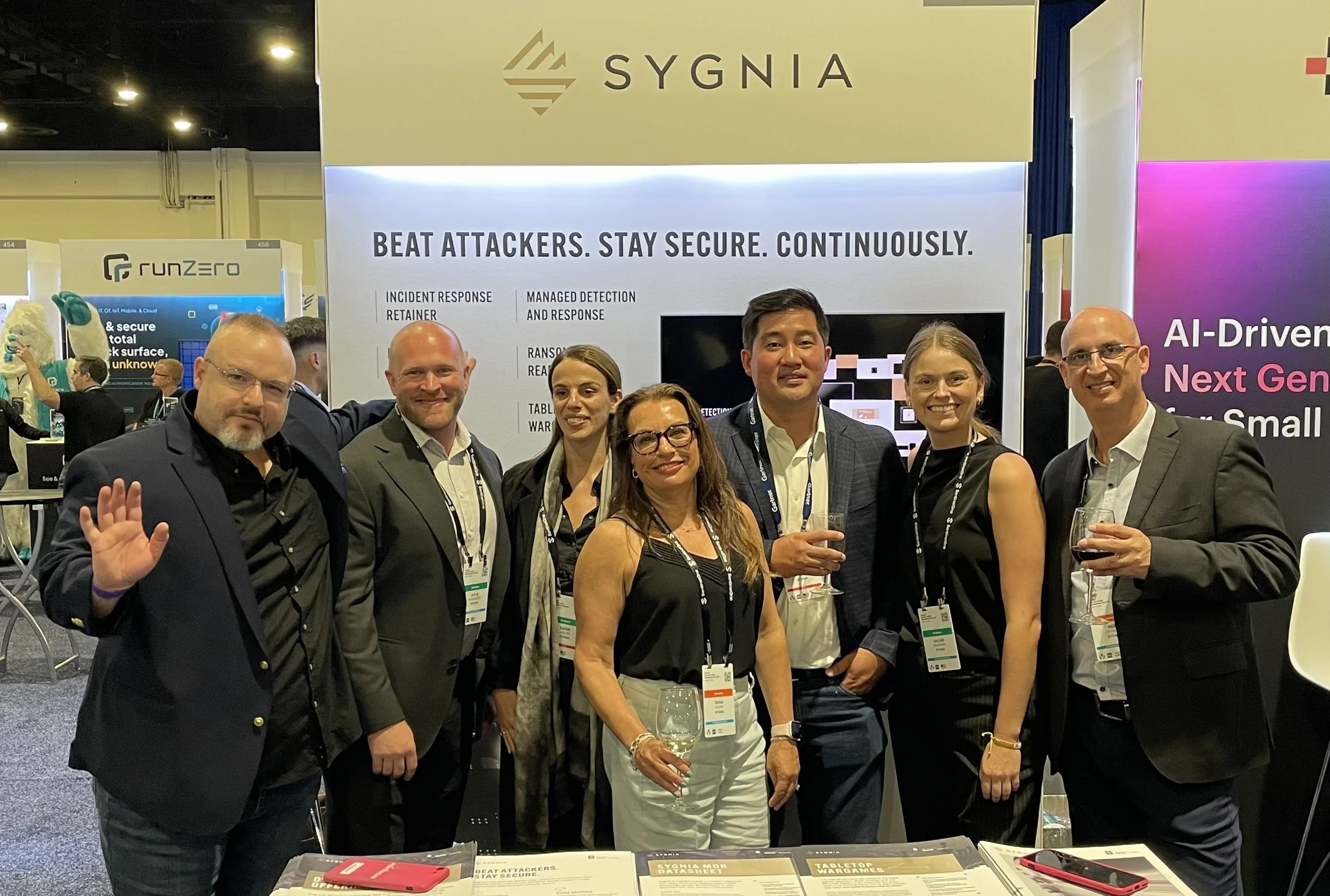 Gentry with the Sygnia Cybersecurity team at their trade show booth, where he performed booth activation.