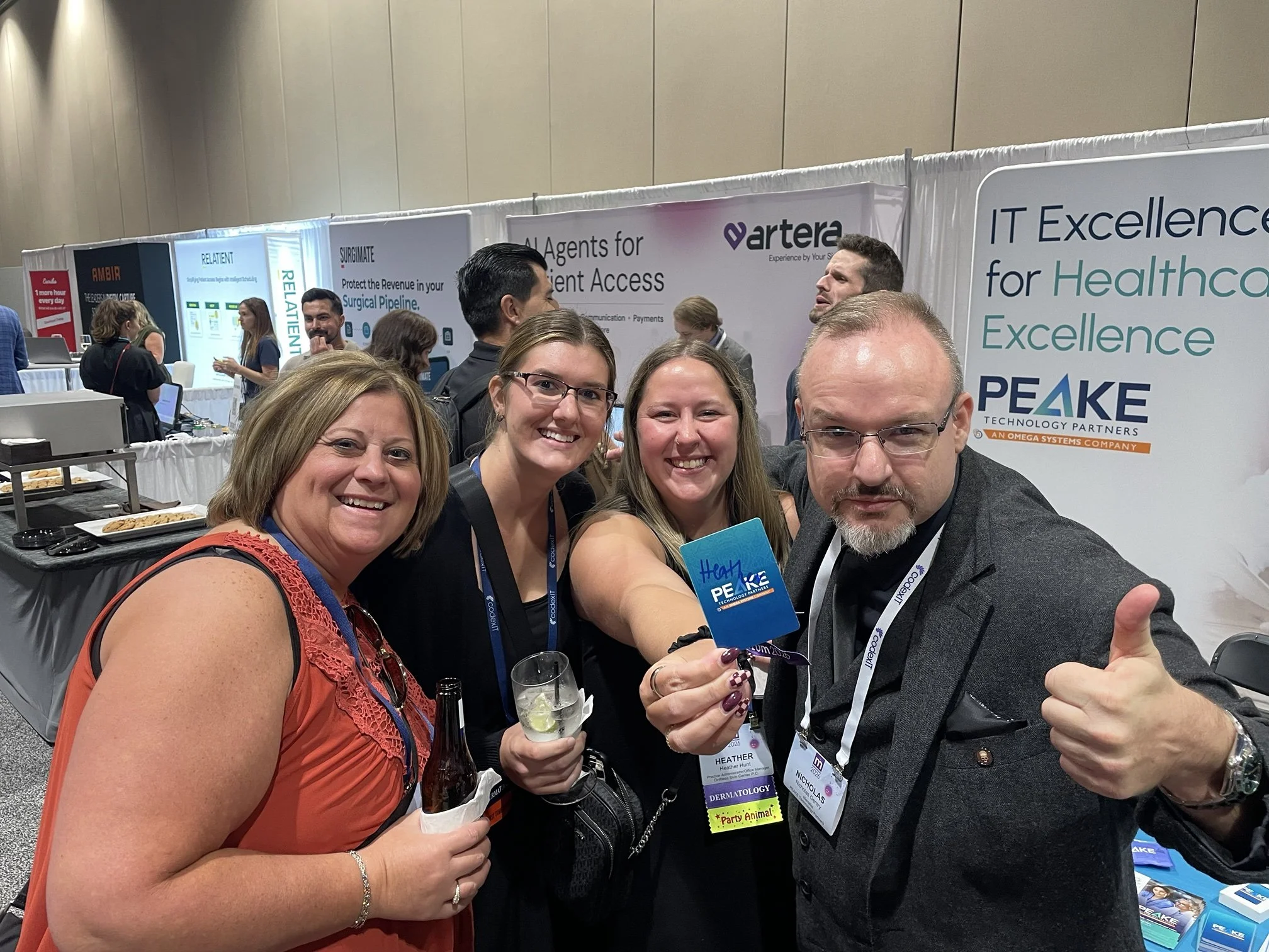 Trade show mentalist Gentry with delighted attendees at the PEAKE Technology booth, ModMed MOMENTUM 2026, Orlando