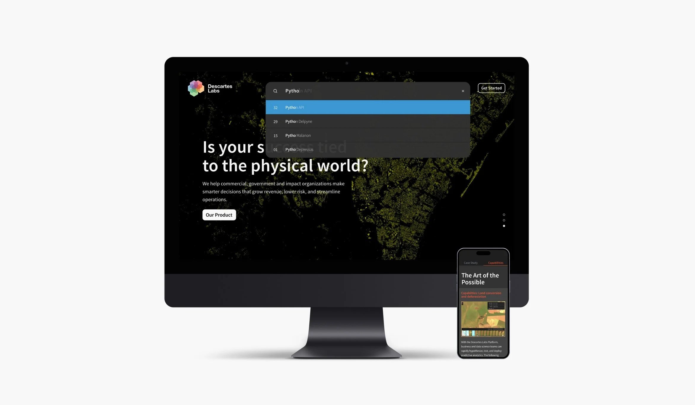 A computer monitor displaying the Descartes Labs website with a search dropdown menu for Python API and a background map, alongside a smartphone showing a program or app related to the platform.