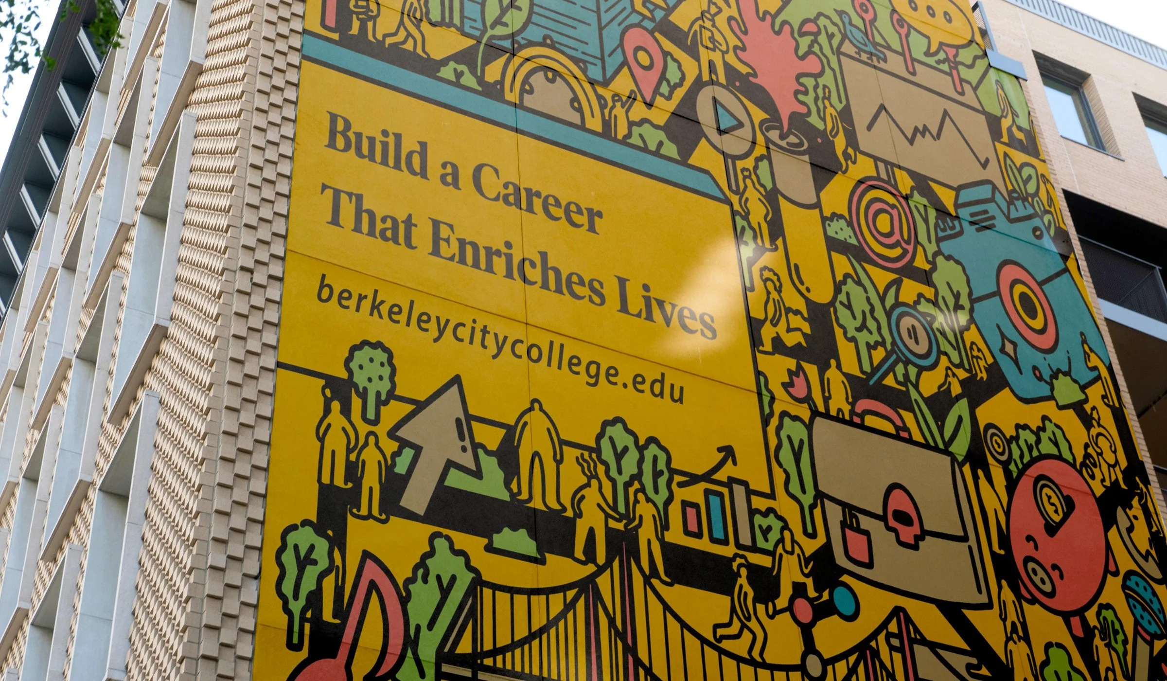 A large colorful mural on the side of a building with drawings of various icons, symbols, and illustrations. Part of the mural contains the text: 'Build a Career That Enriches Lives berkeleycitycollege.edu'.