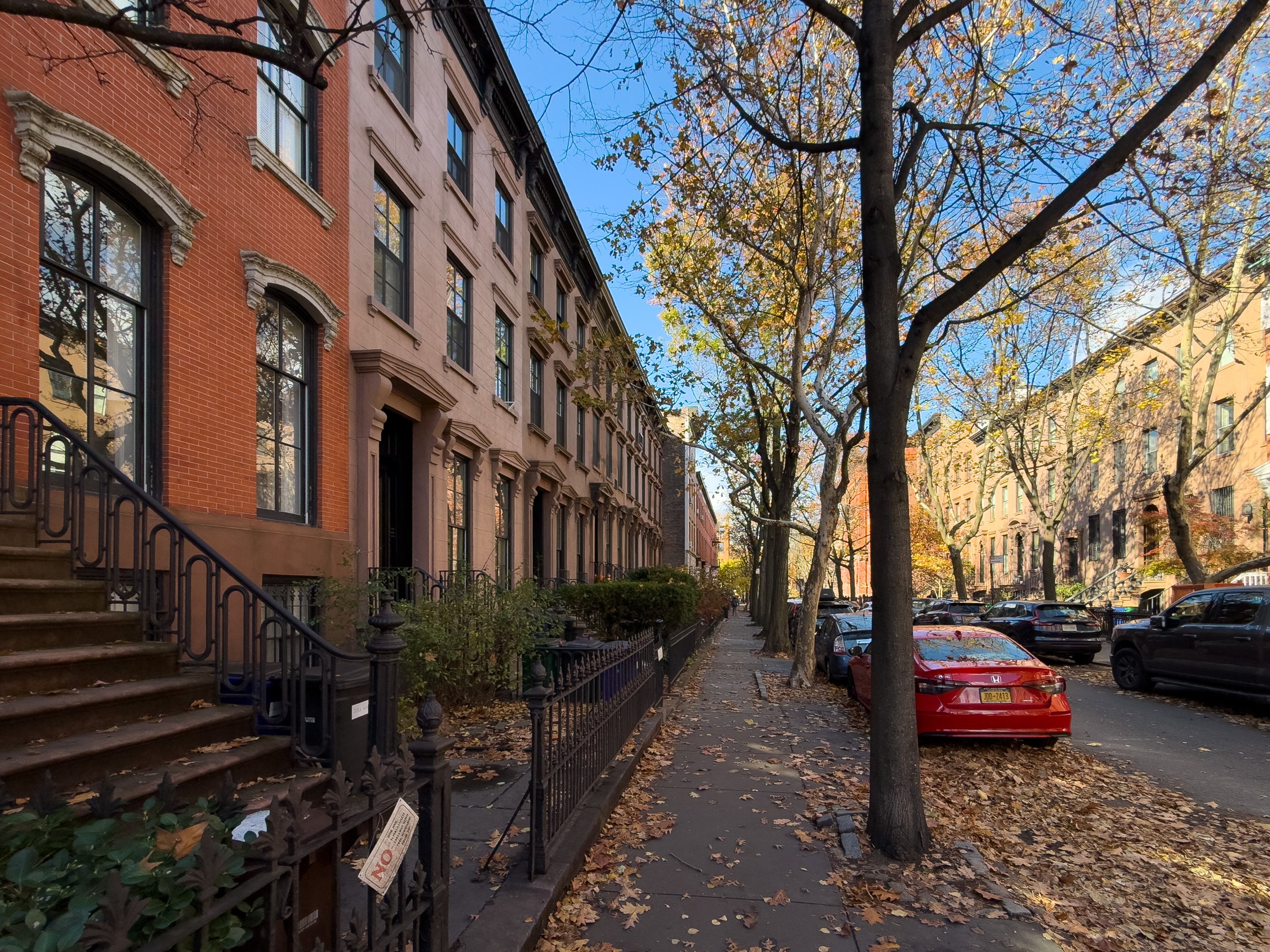 Fall streetscape with historic brownstones in Cobble Hill, Brooklyn, NYC, highlighting the neighborhood’s residential character and real estate appeal.