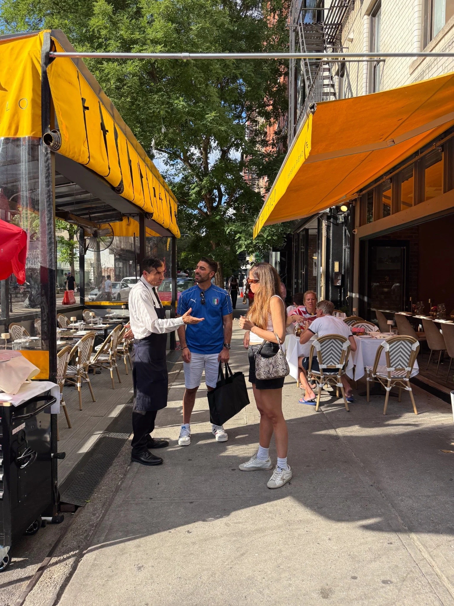 Outdoor dining along a restaurant-lined street in SoHo, Manhattan