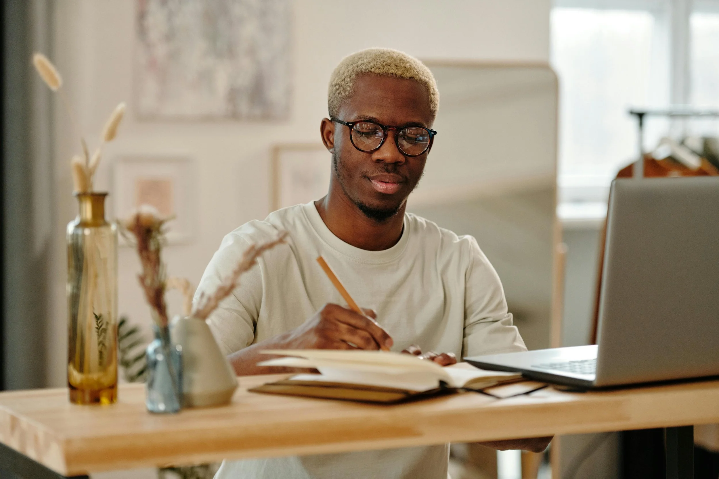 Home buyer reviewing mortgage calculations and financial notes at a desk while evaluating principal, interest, and monthly housing costs.