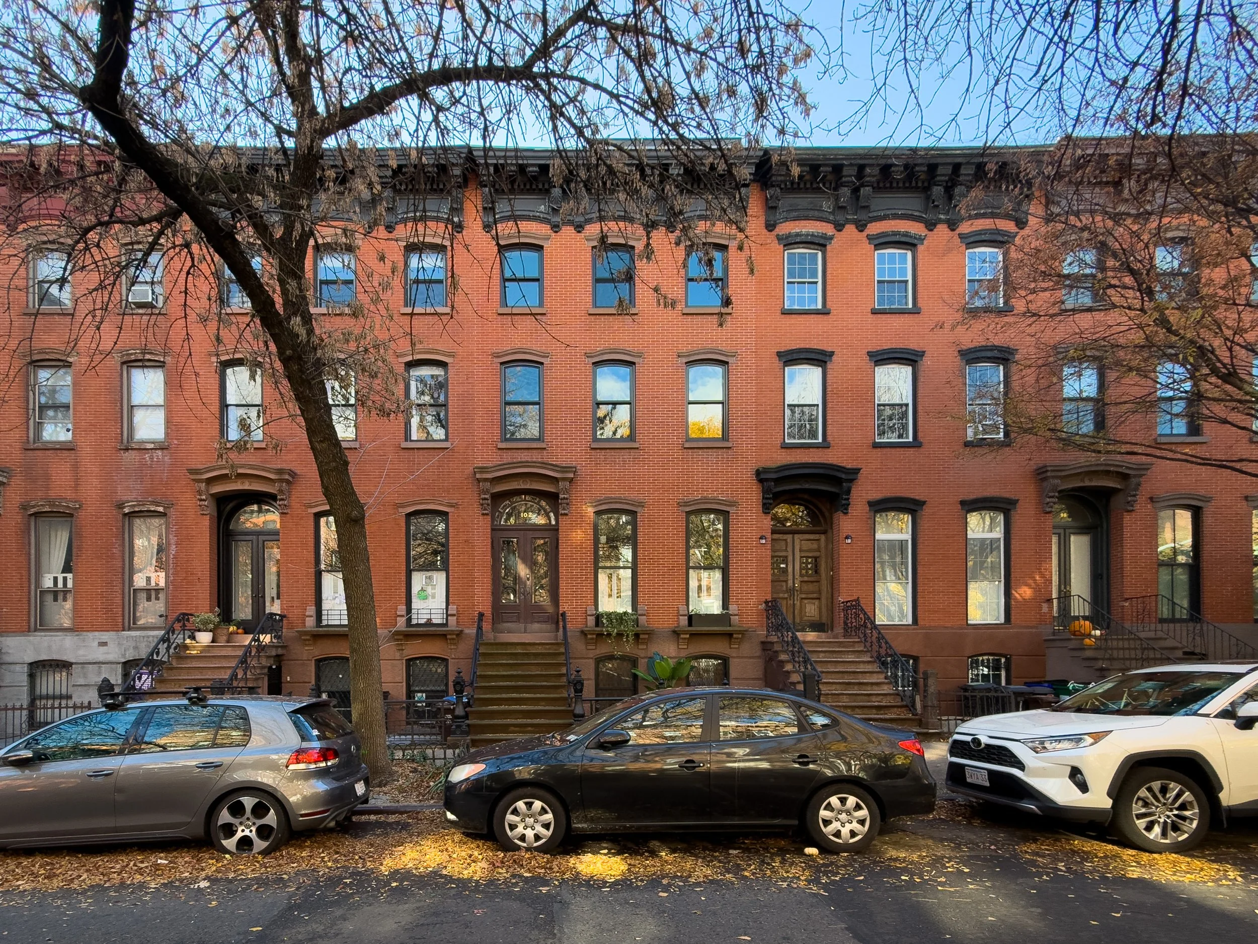 Historic brick townhouses with individual stoops on a residential street in Boerum Hill, Brooklyn, illustrating the neighborhood’s classic architecture and low-density housing character.