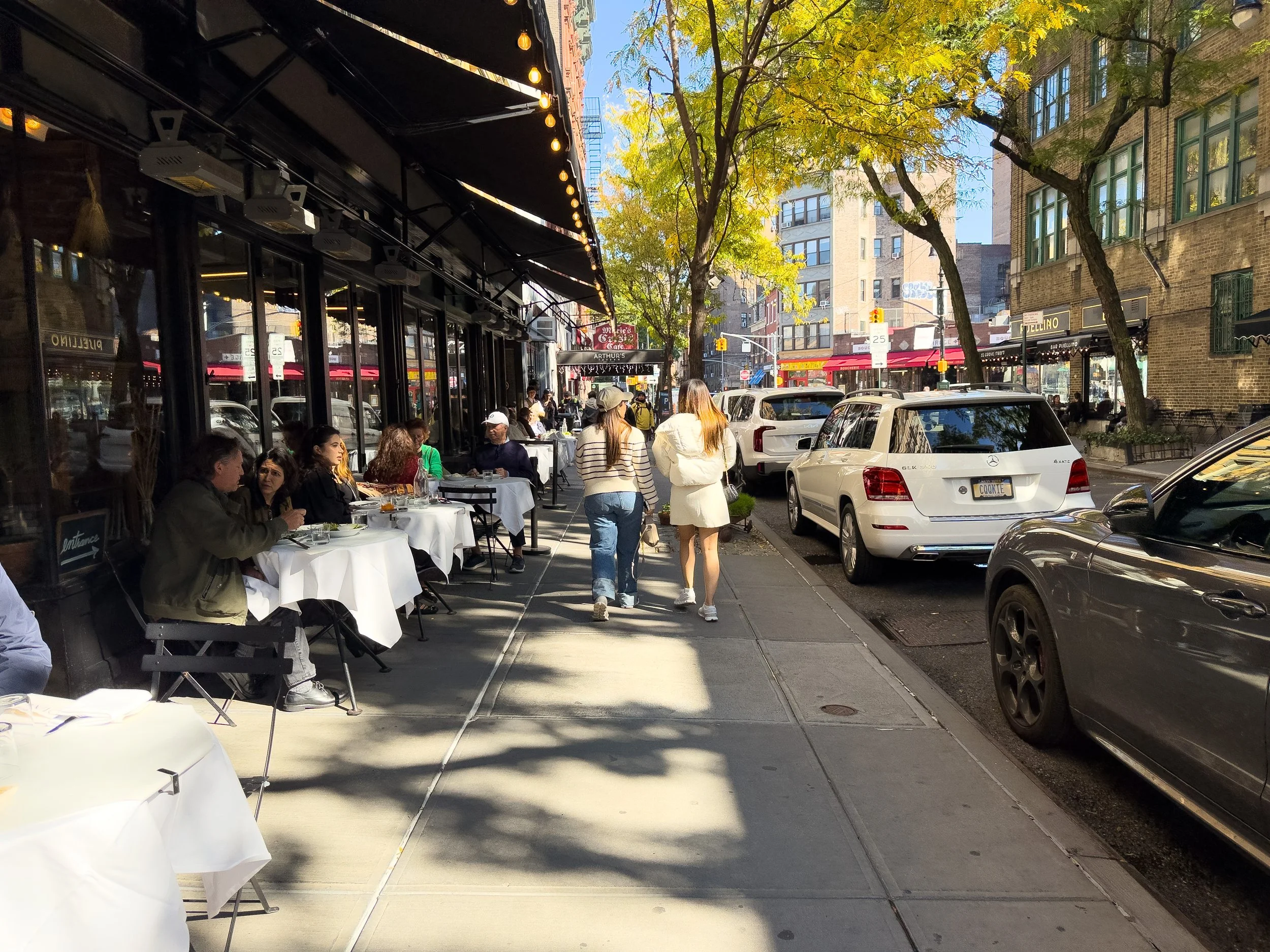 People dining outdoors at Via Carota along Grove Street in the West Village, Manhattan, NYC, capturing the neighborhood’s lively street atmosphere and local lifestyle.