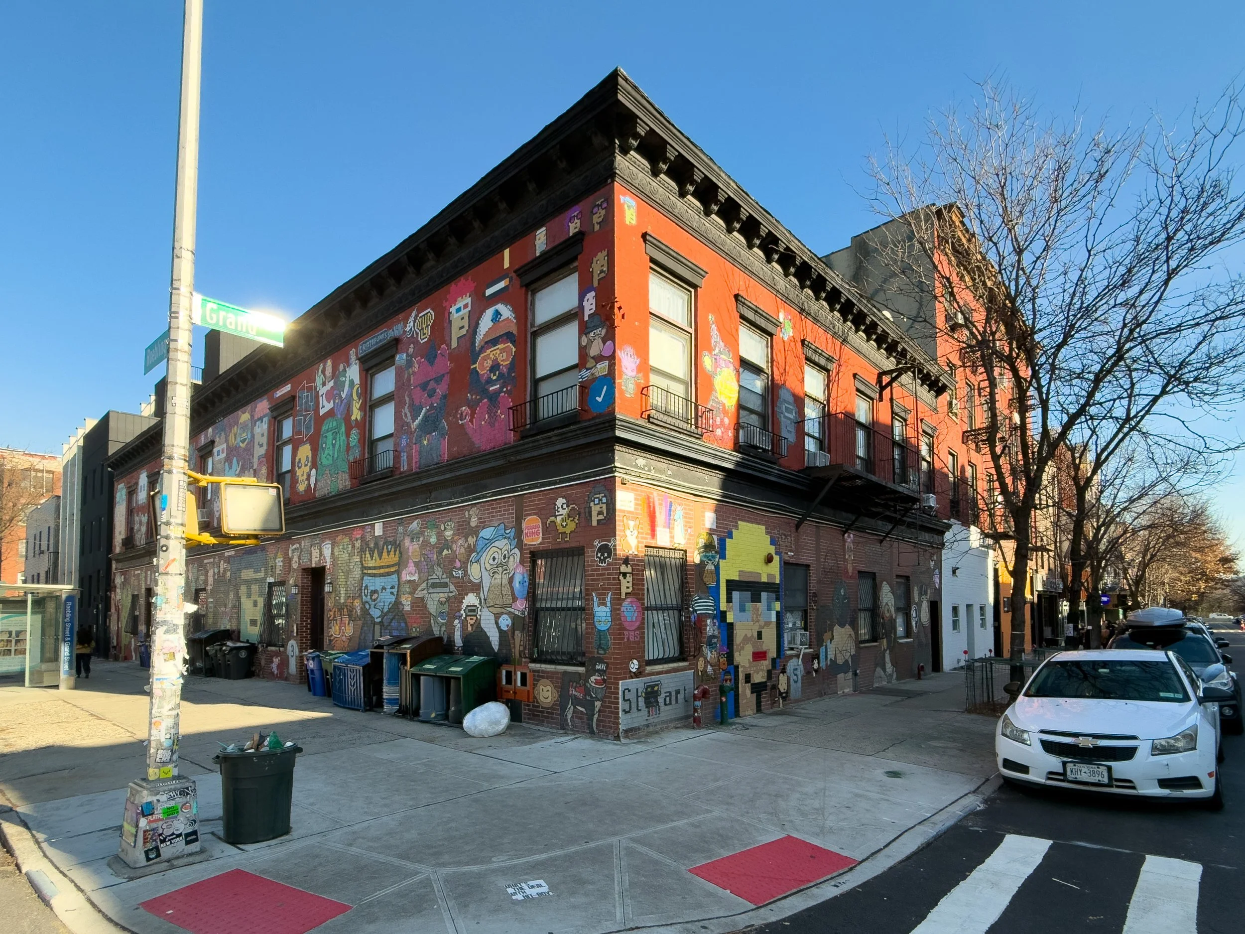Residential corner building with mural art in Williamsburg, Brooklyn, NYC, highlighting the neighborhood’s creative character and urban real estate landscape.