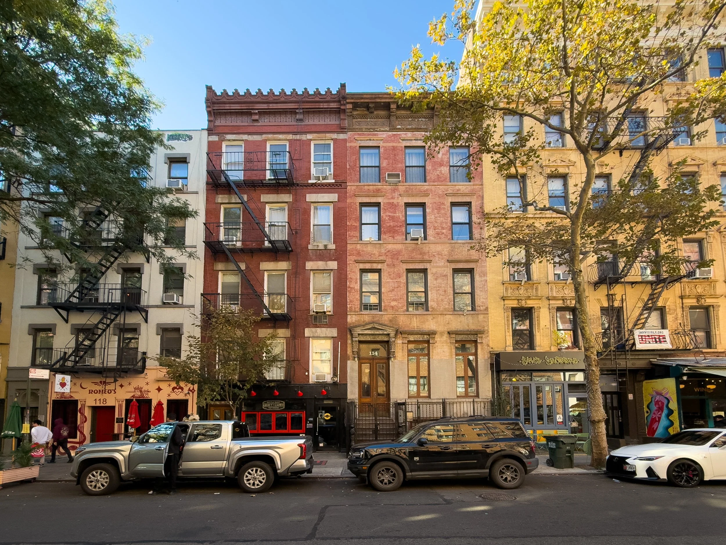 Row of historic tenement buildings with ground-floor retail in the East Village, Manhattan, New York City, highlighting the neighborhood’s mixed-use residential character.