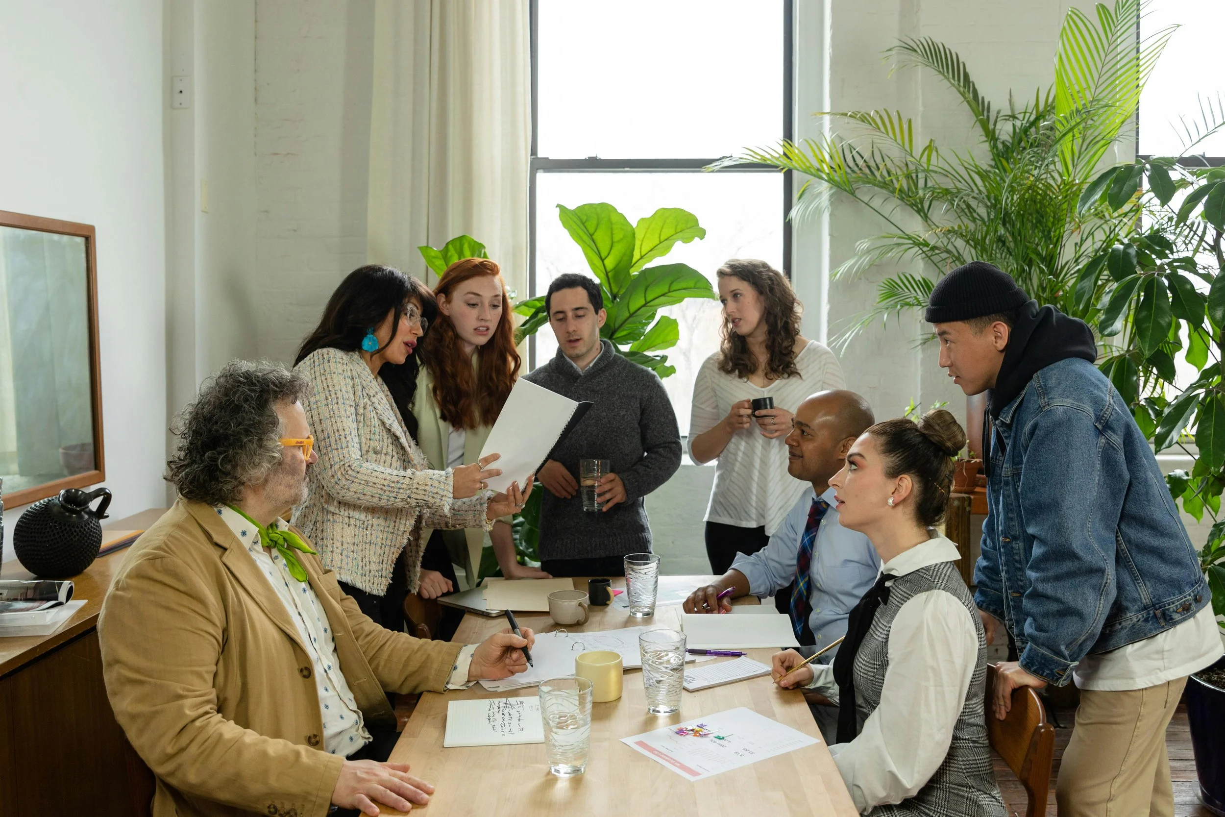 Group of co-op or condo board members reviewing documents during a meeting, illustrating governance and decision-making in NYC residential buildings.