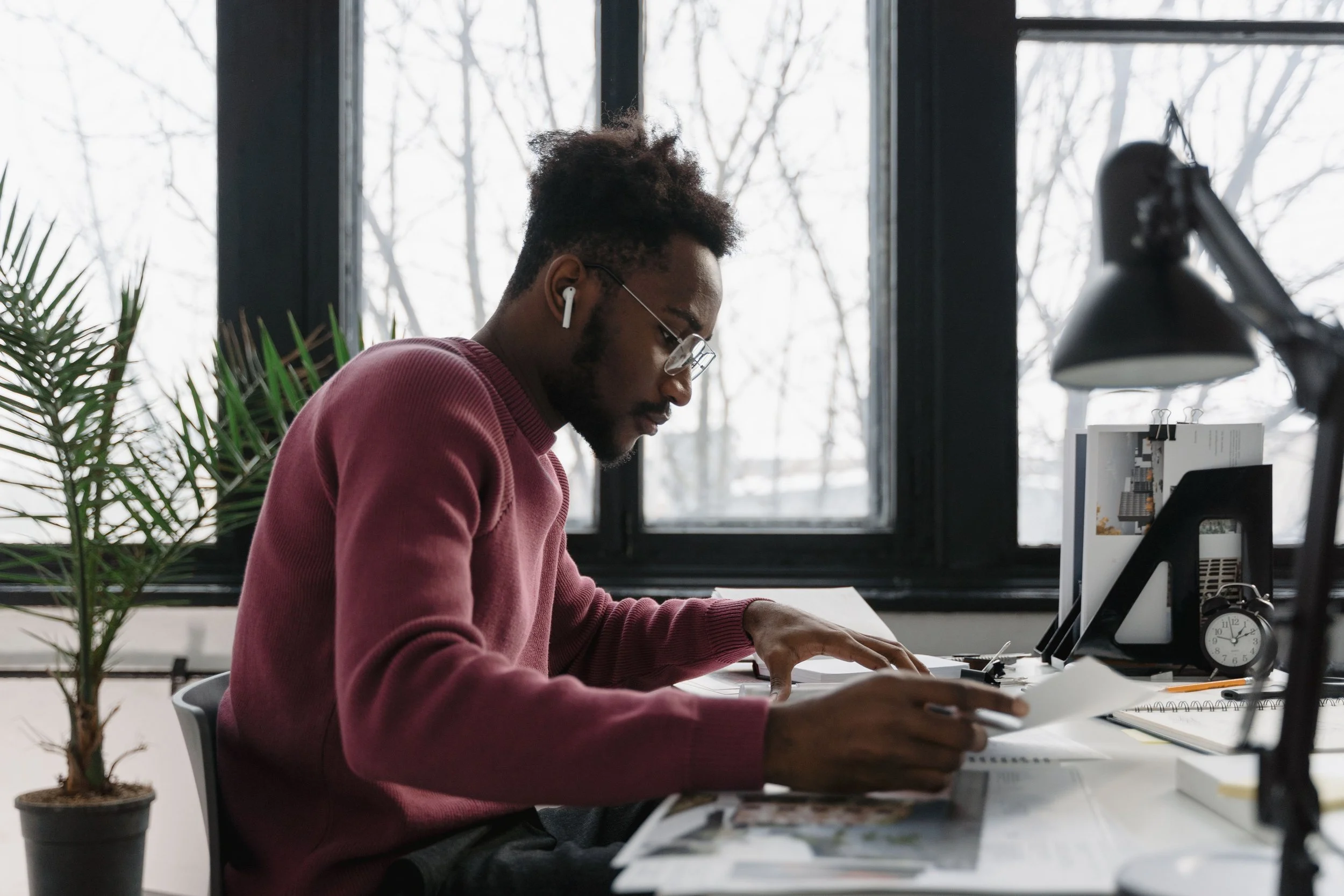 Man reviewing financial documents at a desk for a New York City real estate transaction.