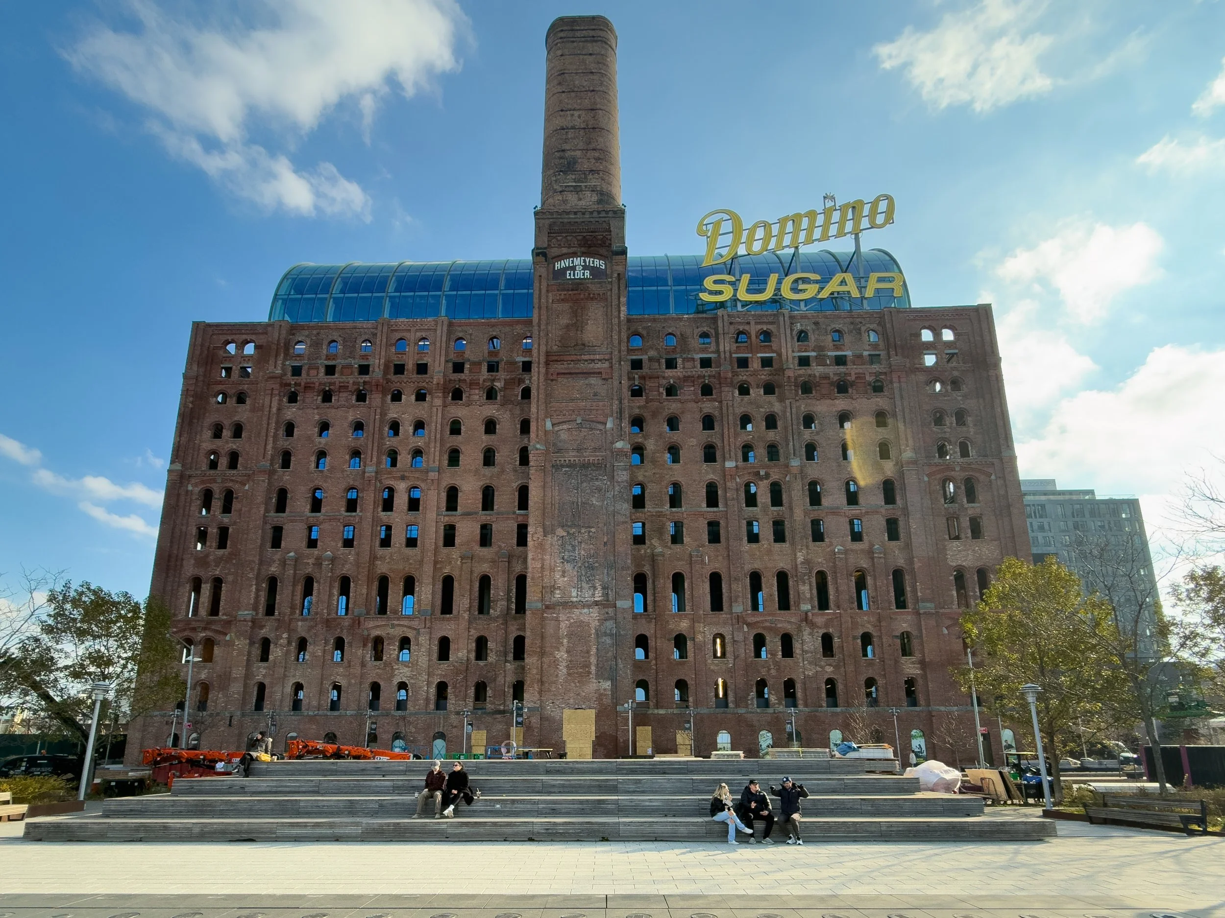 Domino Sugar Factory redevelopment along the Williamsburg waterfront in Brooklyn, NYC, illustrating the neighborhood’s large-scale residential growth and evolving real estate landscape.