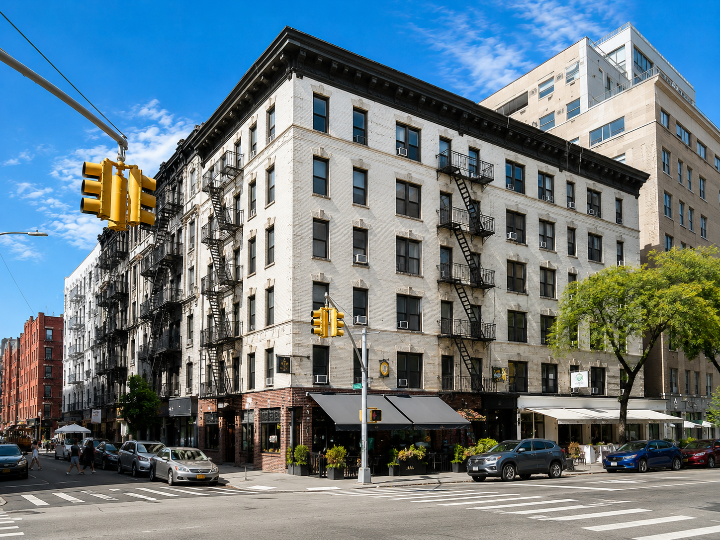 Historic mixed-use residential building with ground-floor dining in Nolita, Manhattan, highlighting the neighborhood’s low-rise architecture and real estate character.