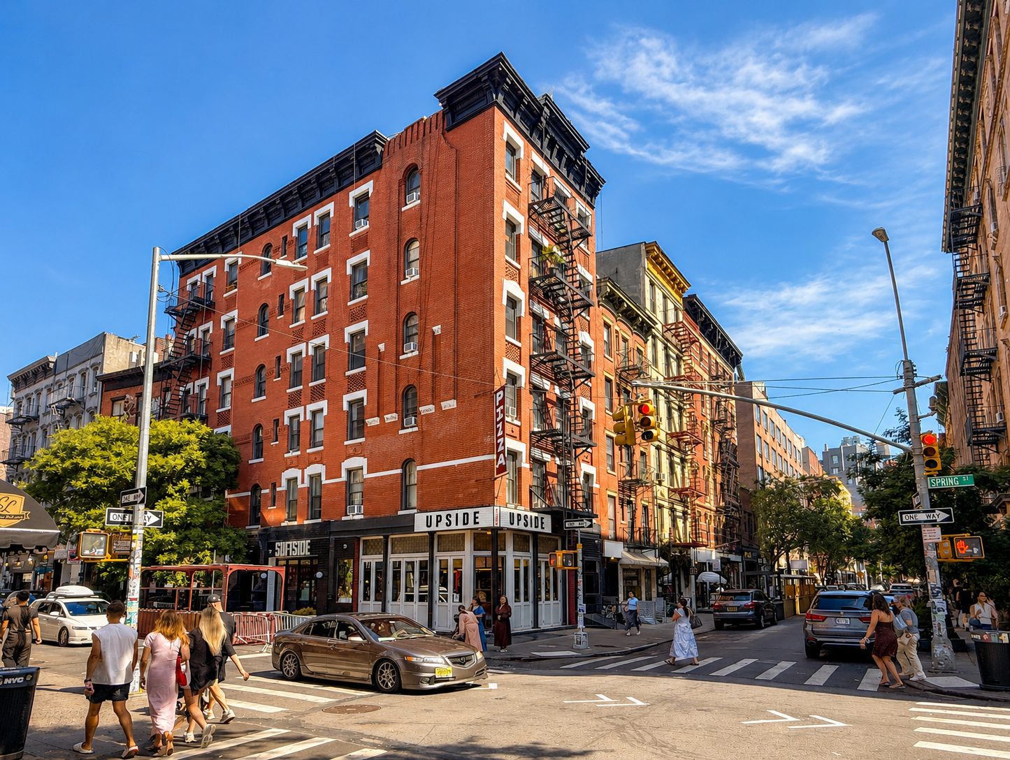 Historic corner building and neighborhood streetscape in Nolita, Manhattan, illustrating the area's residential, retail, and real estate character.