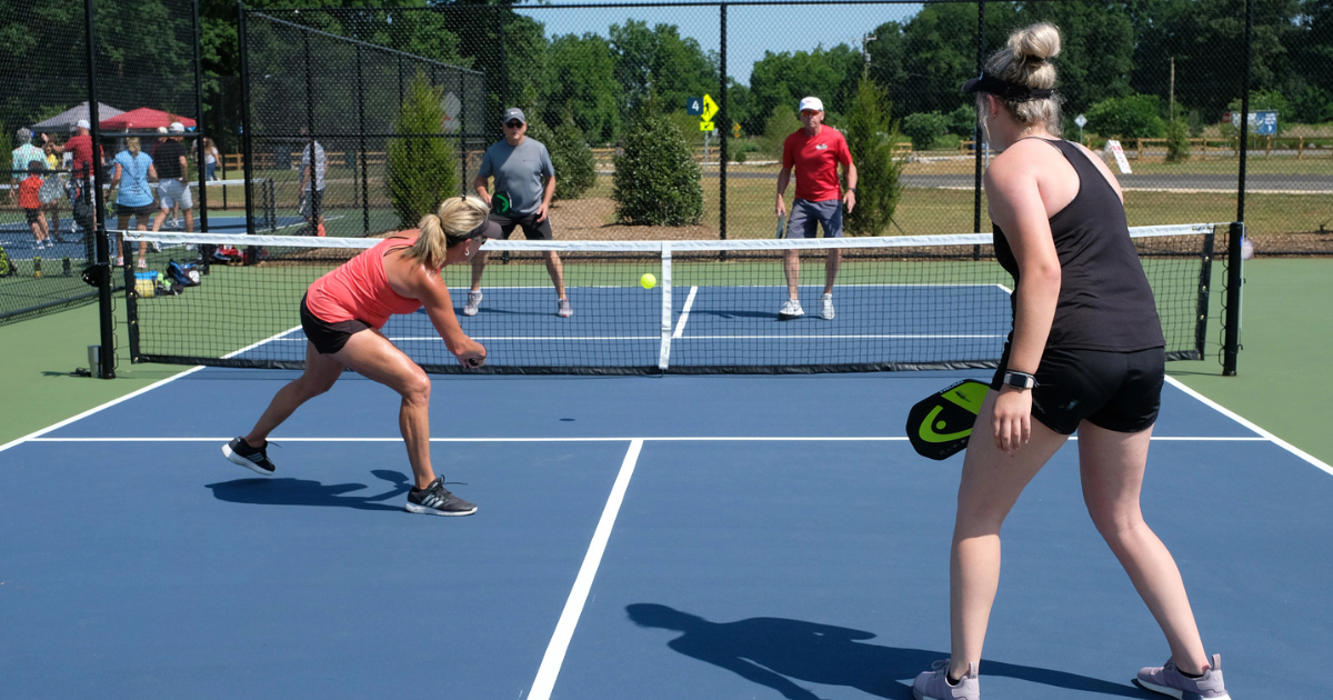 Pickleball courts in Charlotte, NC packed with players.
