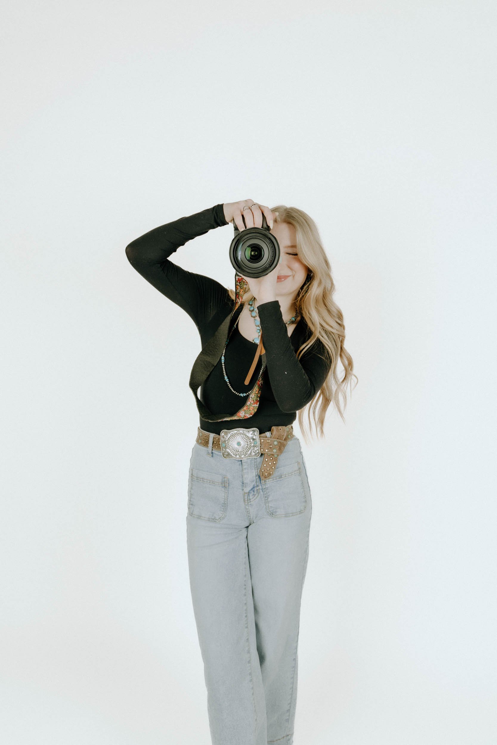 Photographer looking at a camera and smiling while taking a photo