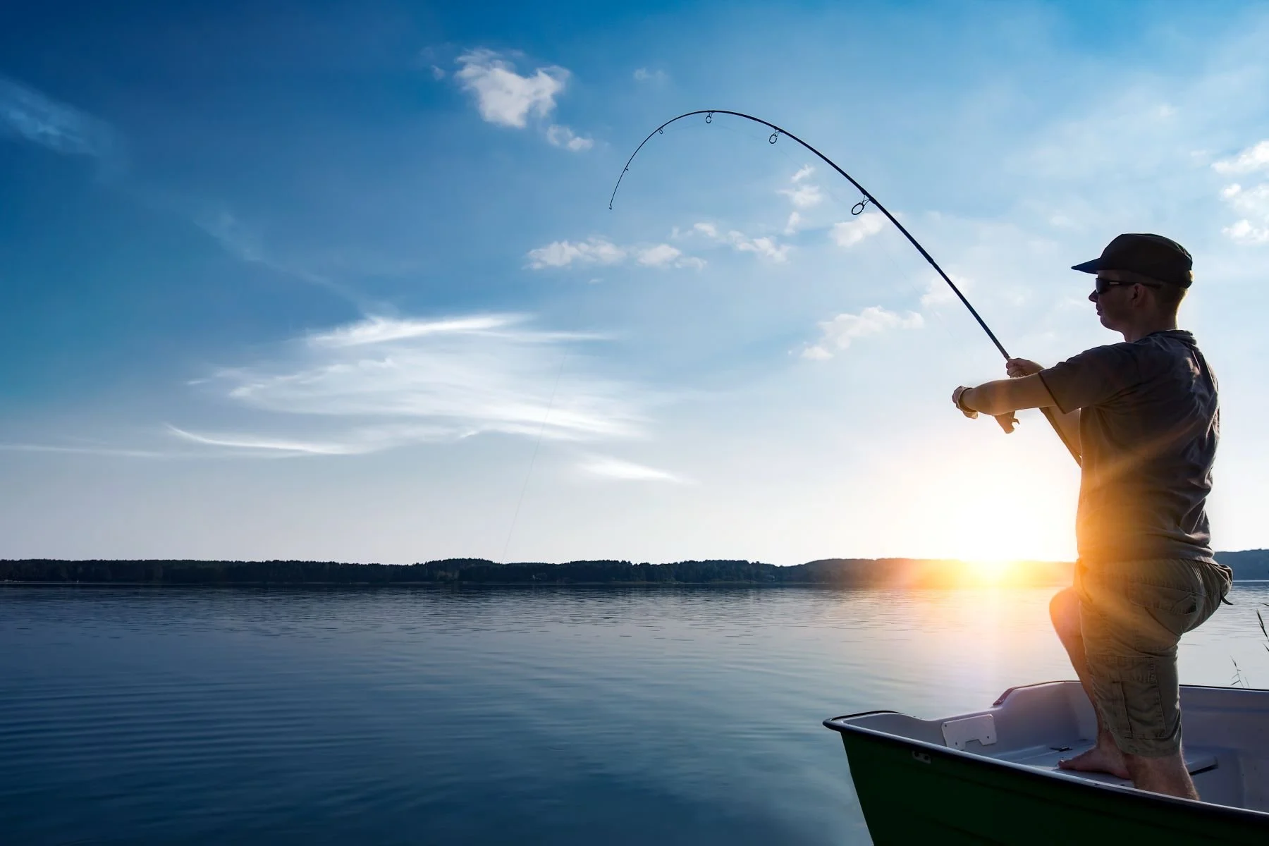 A man standing on a boat holds a very large fish, possibly a catfish, caught in Lake Tawakoni Texas