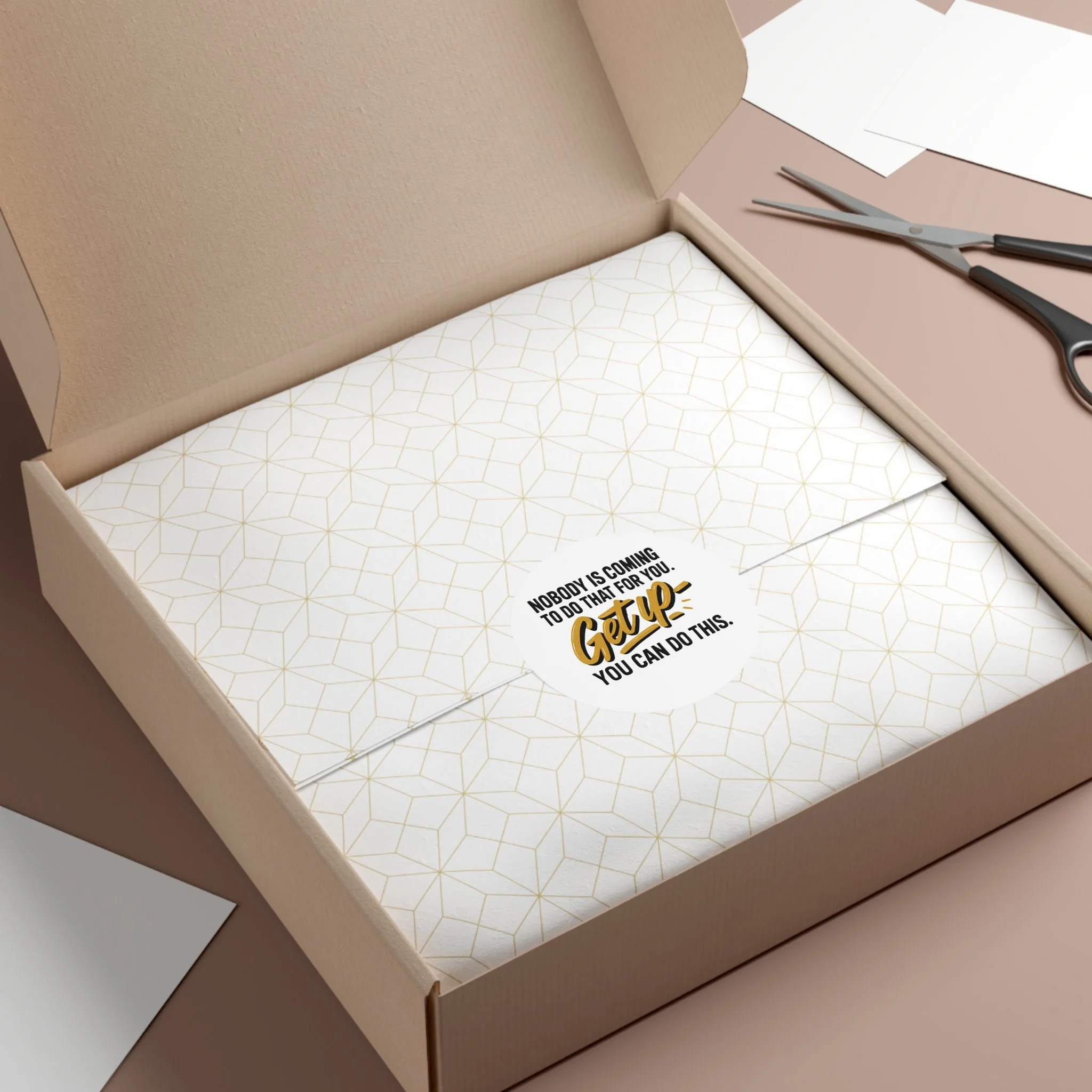 Round matte vinyl sticker with hand-lettered gold “Get up” and bold black type, motivational design for laptops and water bottles.