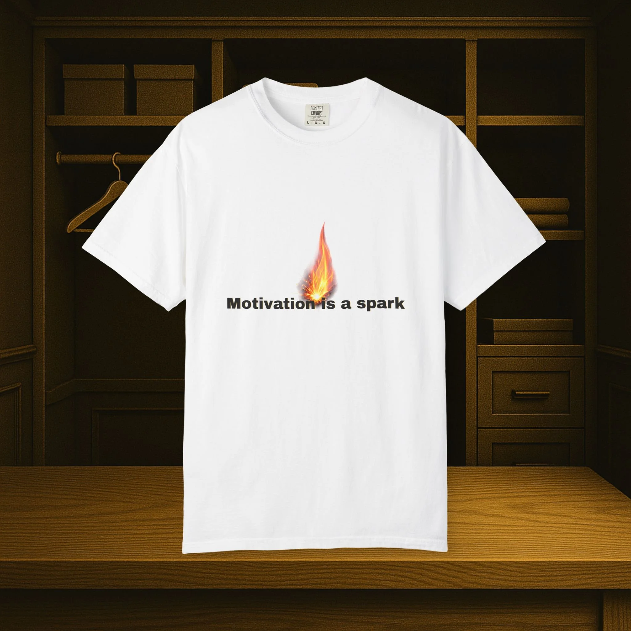 Front view of garment-dyed motivational T-shirt with 'Motivation Is The Spark...' design.