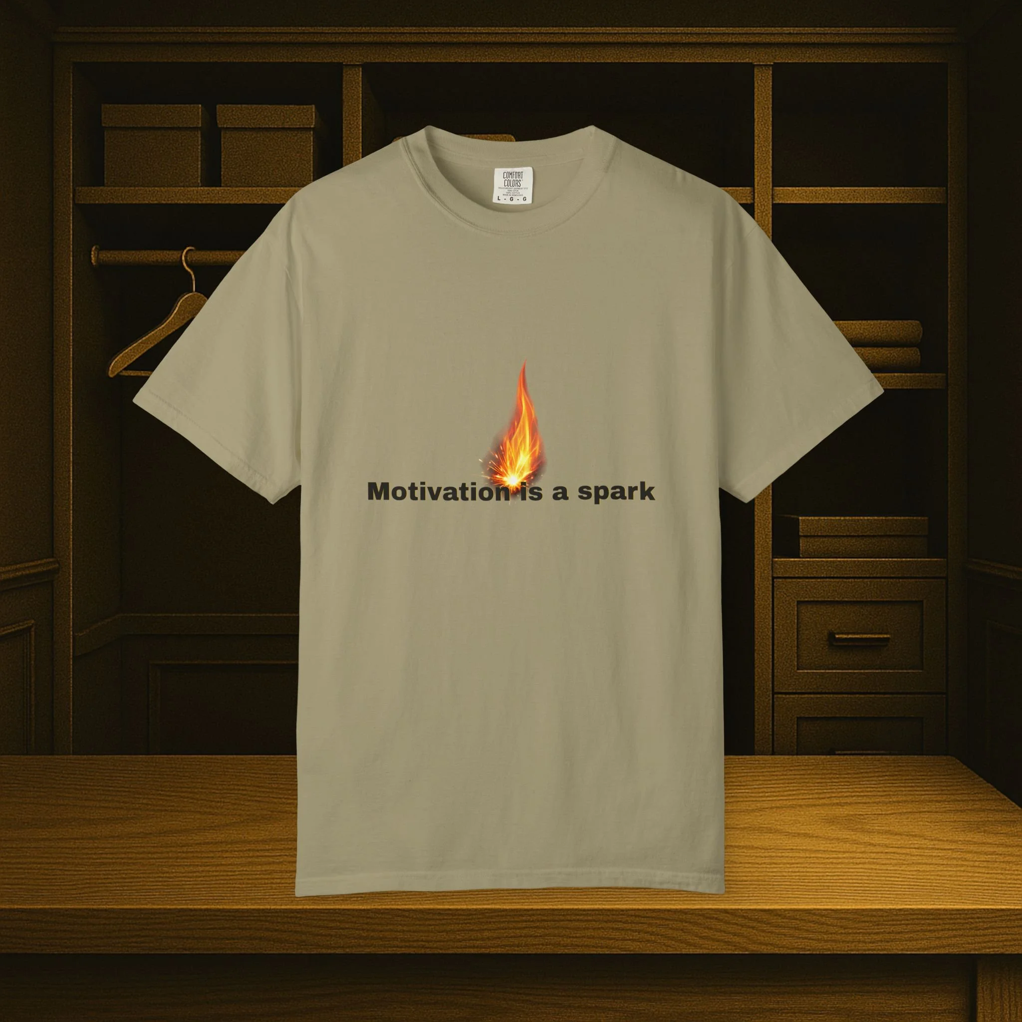 Front view of garment-dyed motivational T-shirt with 'Motivation Is The Spark...' design.