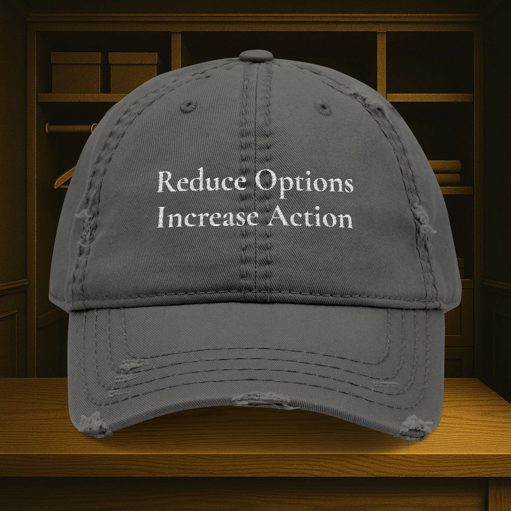 Front view of distressed dad hat with embroidered 'Reduce Options Increase Action' message.