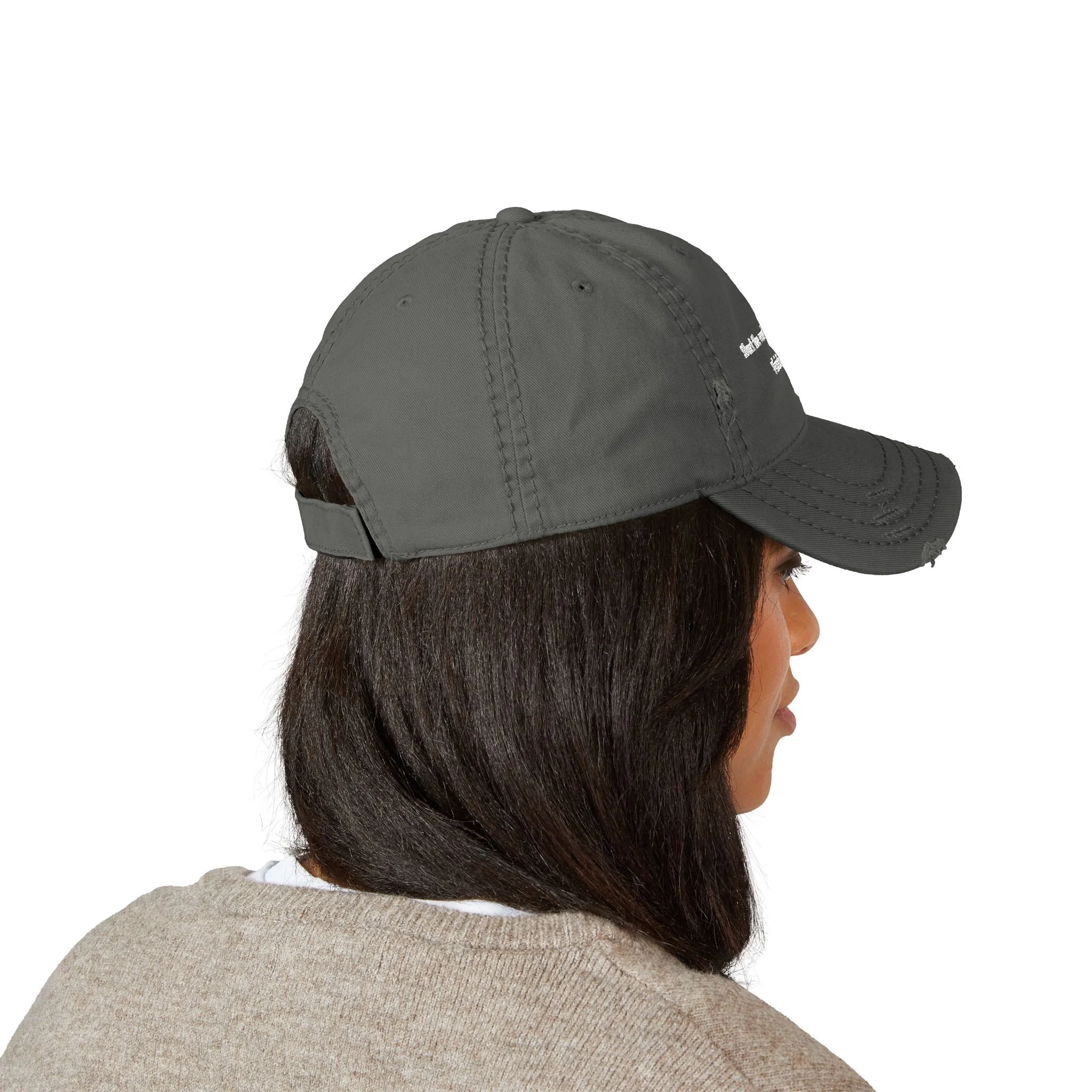 Lifestyle side view of person wearing distressed dad hat with embroidered “Start the Work. Keep Moving. Finish Strong.” message