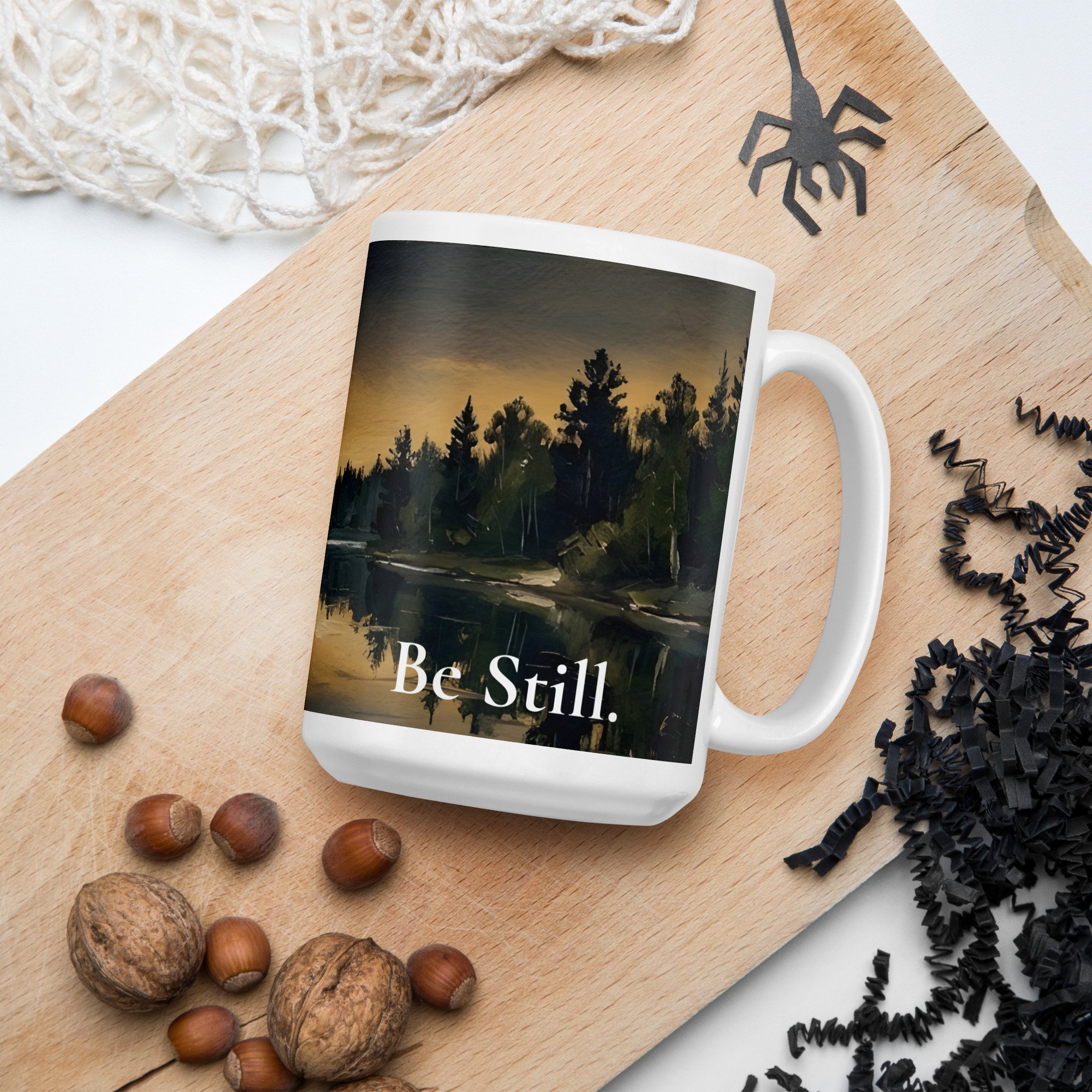 Close-up of the "Be Still" design printed on a white 15 oz. ceramic mug.