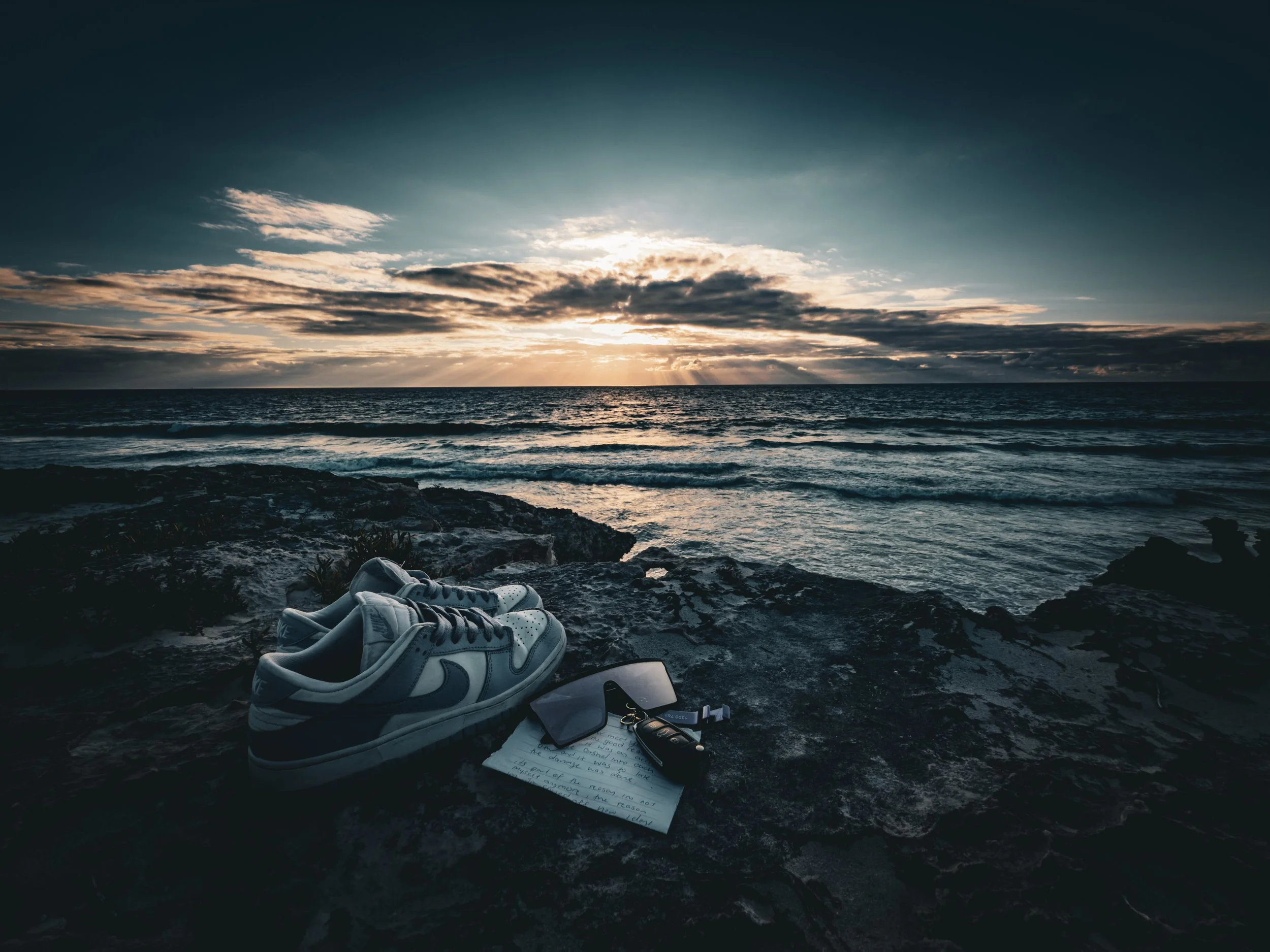 The waves rolled in as they always do, but the spot where someone had once sat was now empty. Only a pair of shoes, a note, and a few personal things were left behind.
No one had seen it coming. They always smiled, laughed at the right times, never l