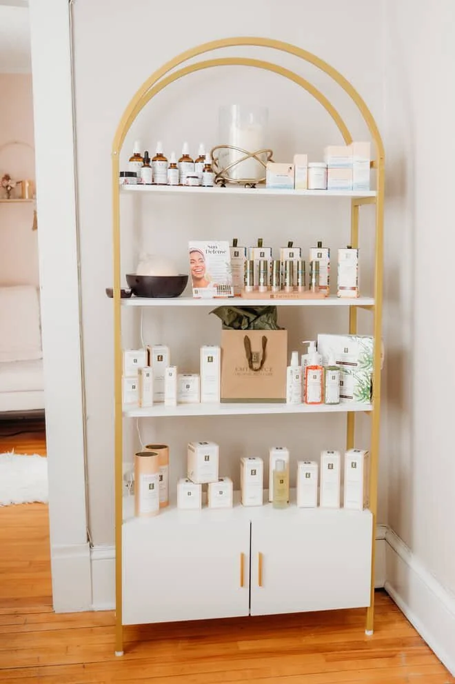 Local skin products on a wooden shelf with towels | Skin treatments Vermont