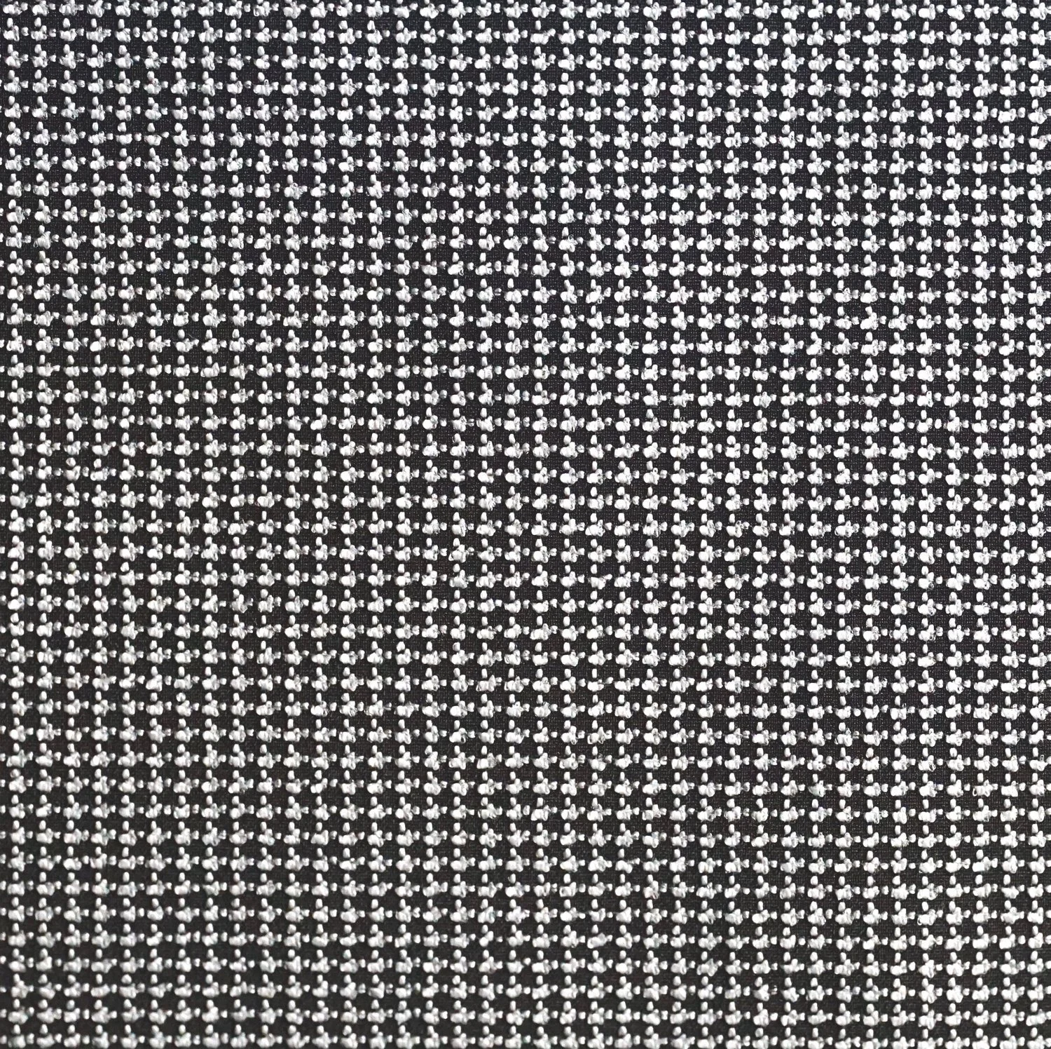 Un motif en forme de grille composée de petits points blancs sur fond noir, formant une texture régulière et complexe.