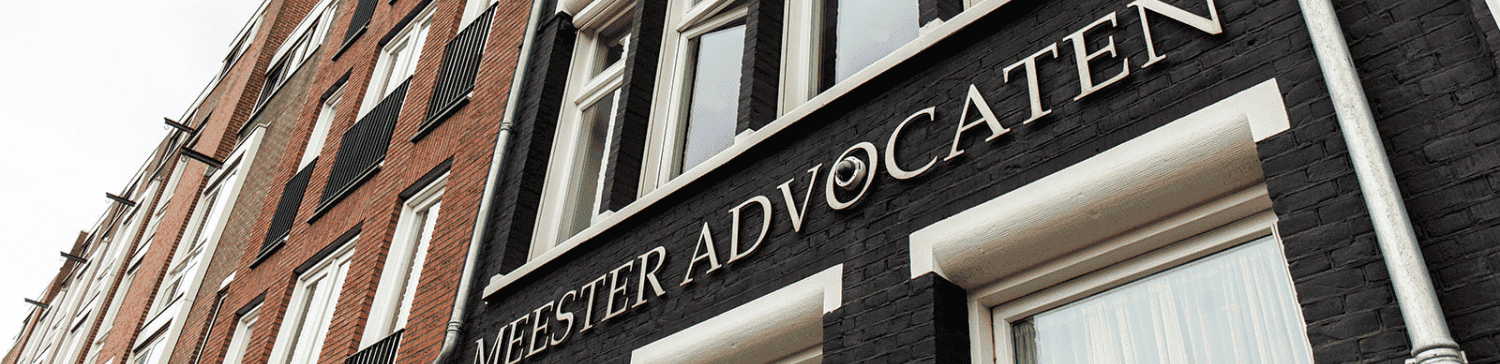 Facade of Meester Advocaten building with windows and signage in Amsterdam.