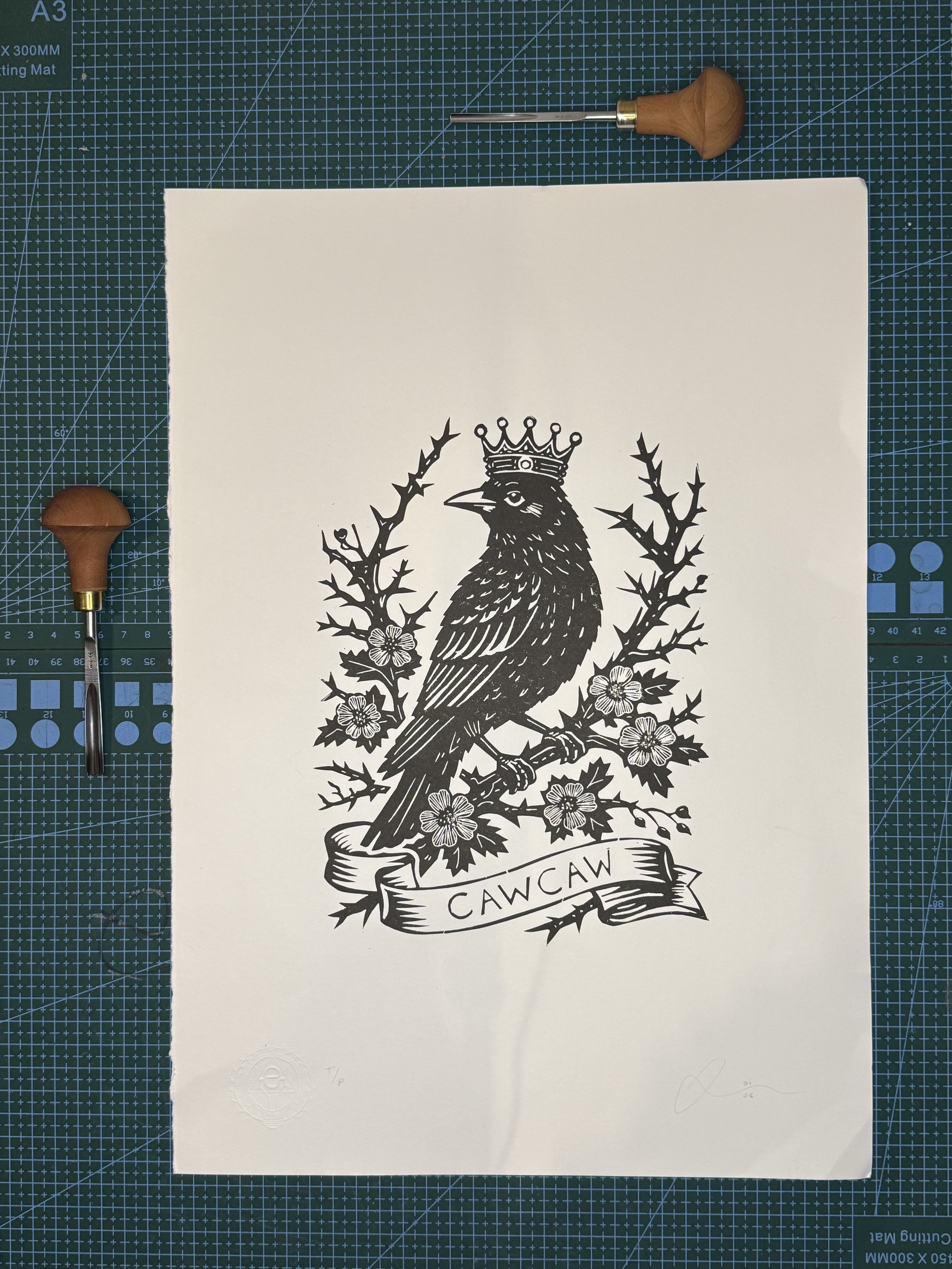 Hand printed linocut of a crowned crow surrounded by thorn blossoms. Limited edition of 20. Folk symbolism, tattoo-flash style print by Elucidation Inc.