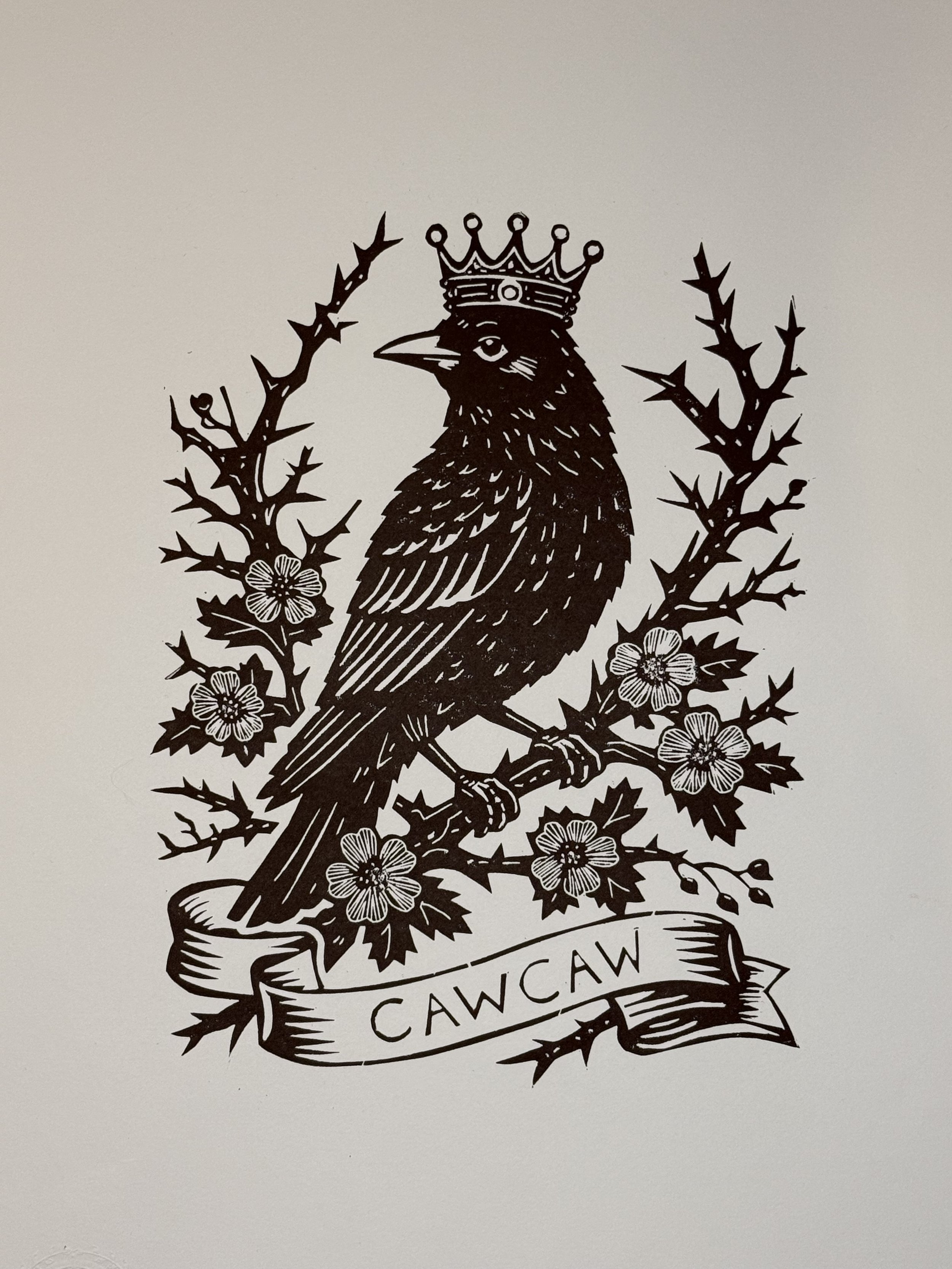 Hand printed linocut of a crowned crow surrounded by thorn blossoms. Limited edition of 20. Folk symbolism, tattoo-flash style print by Elucidation Inc.