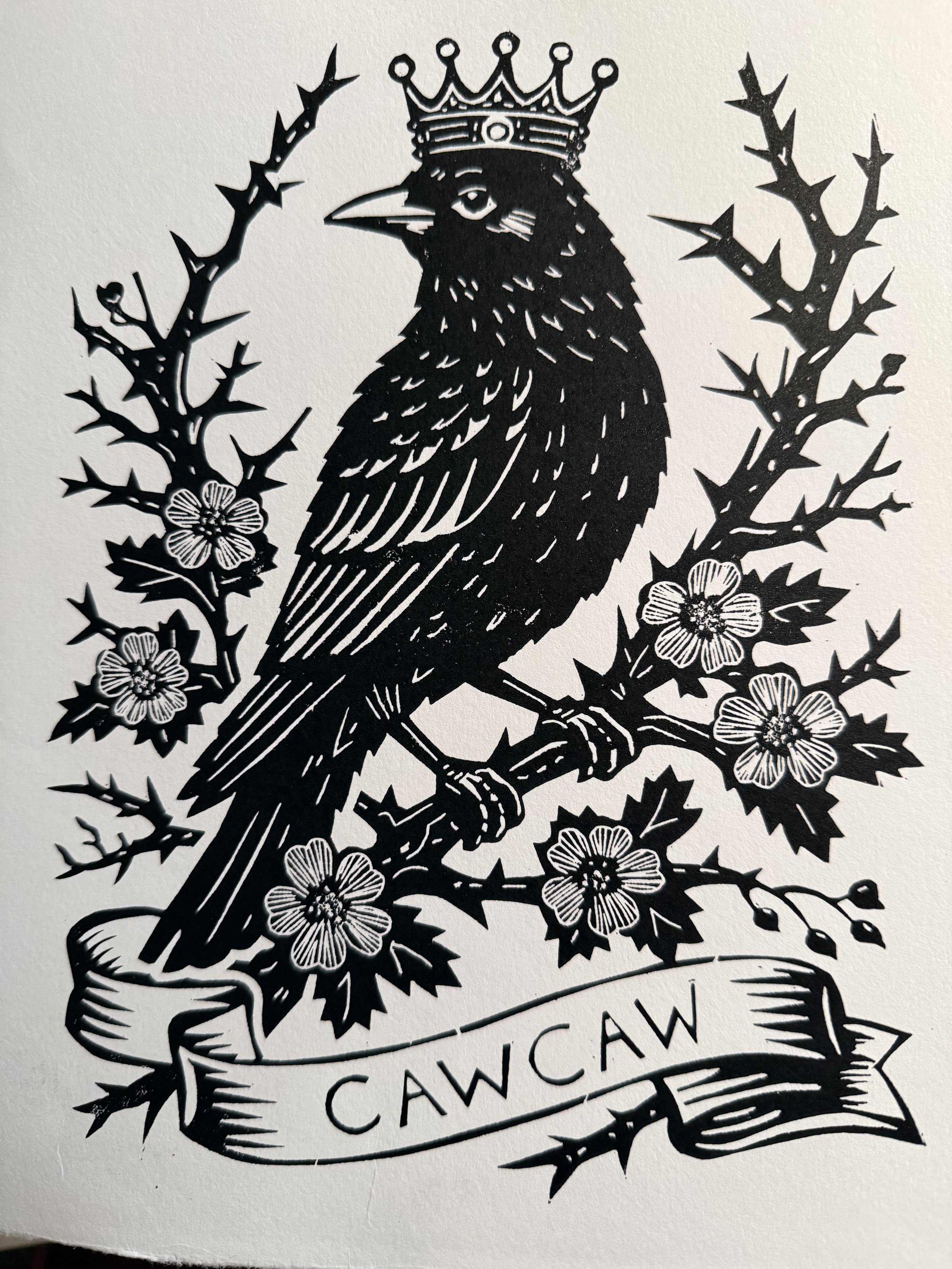 Hand printed linocut of a crowned crow surrounded by thorn blossoms. Limited edition of 20. Folk symbolism, tattoo-flash style print by Elucidation Inc.
