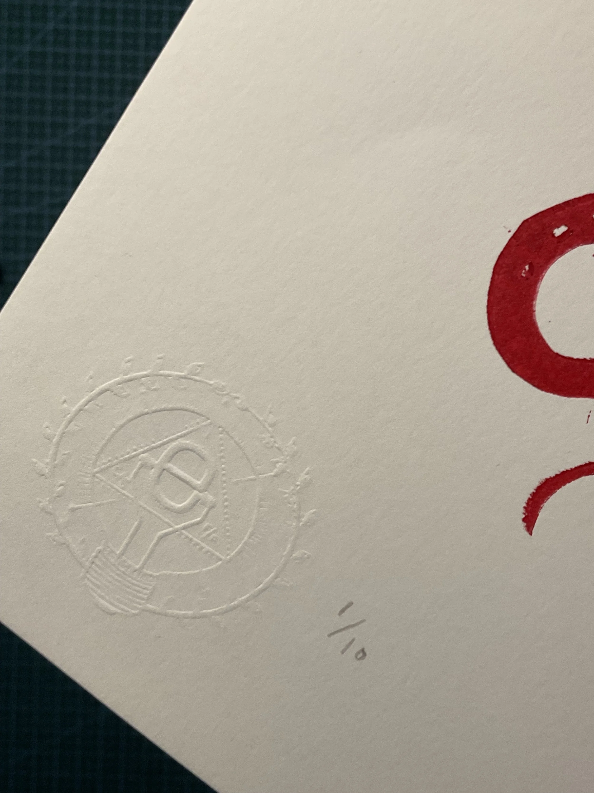 Red linocut tattoo flash print featuring a vintage teapot, lighthouse, revolver with ‘BANG’ flag, snake, key, swallow and flaming torch. Hand-carved and hand-printed by Elucidation Inc.