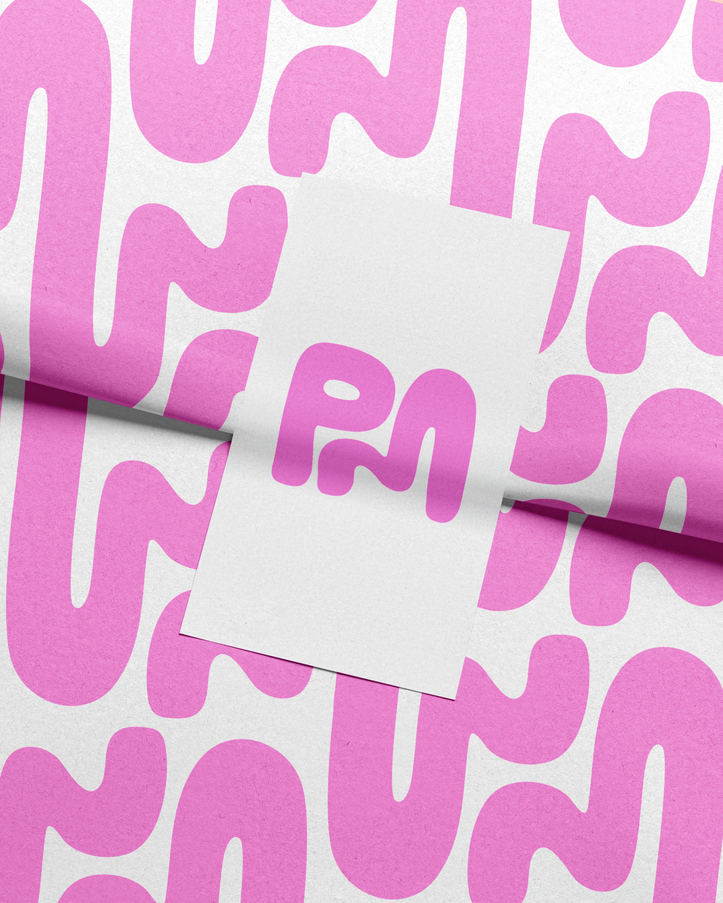 Close-up of paper with pink and purple abstract lettering on a white background.