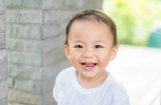 Smiling toddler with some missing teeth